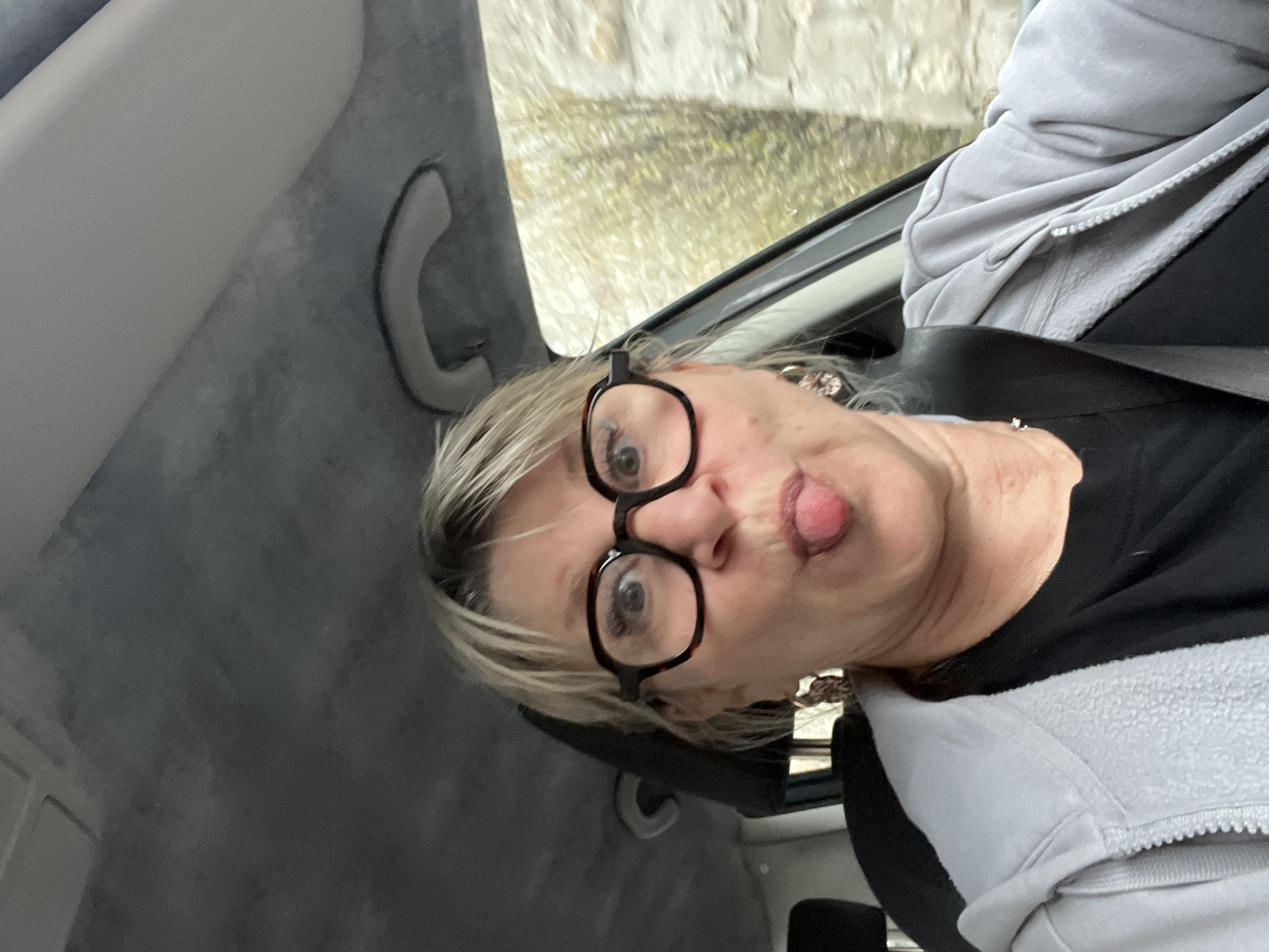 Woman makes playful face during car ride in Saint-Galmier