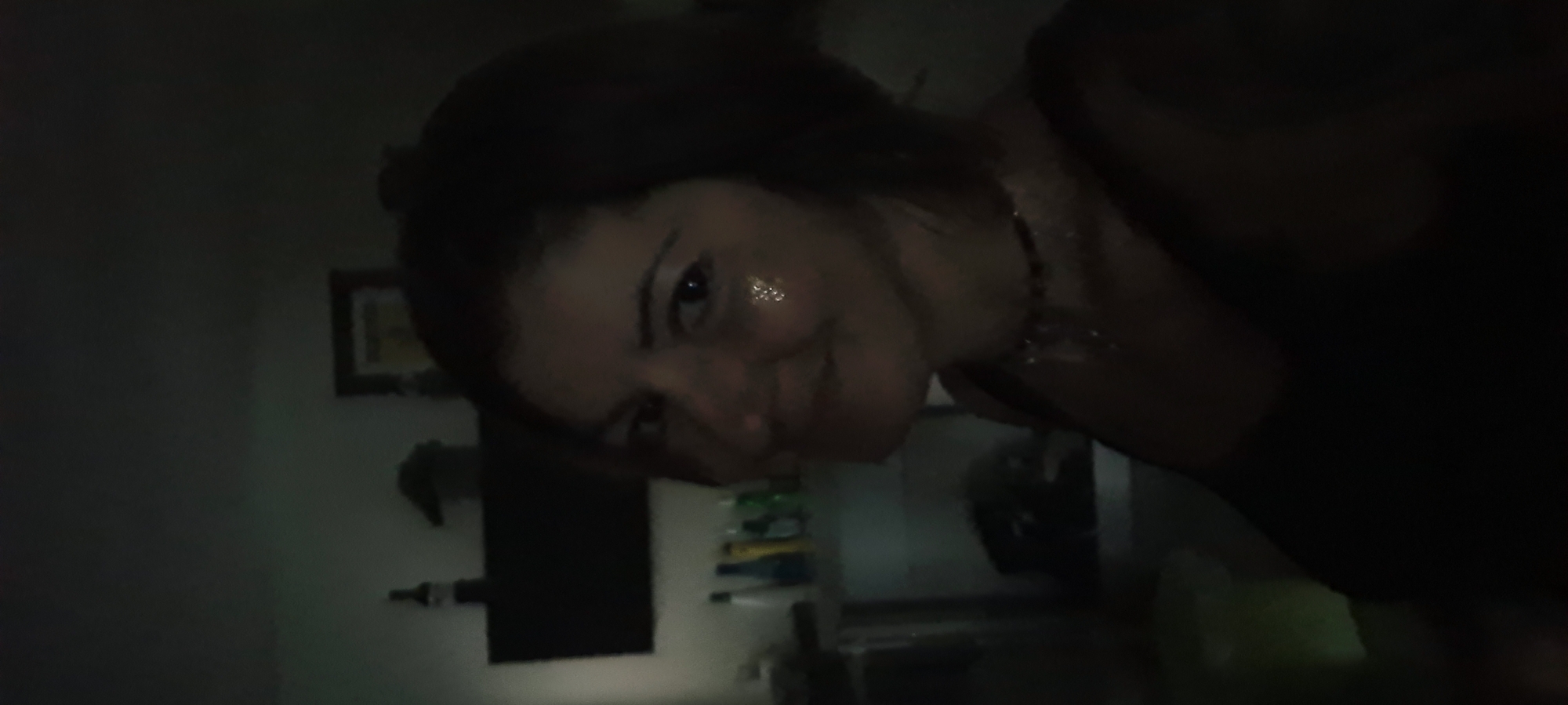 Woman photographed in dimly lit room in Rishon LeZion