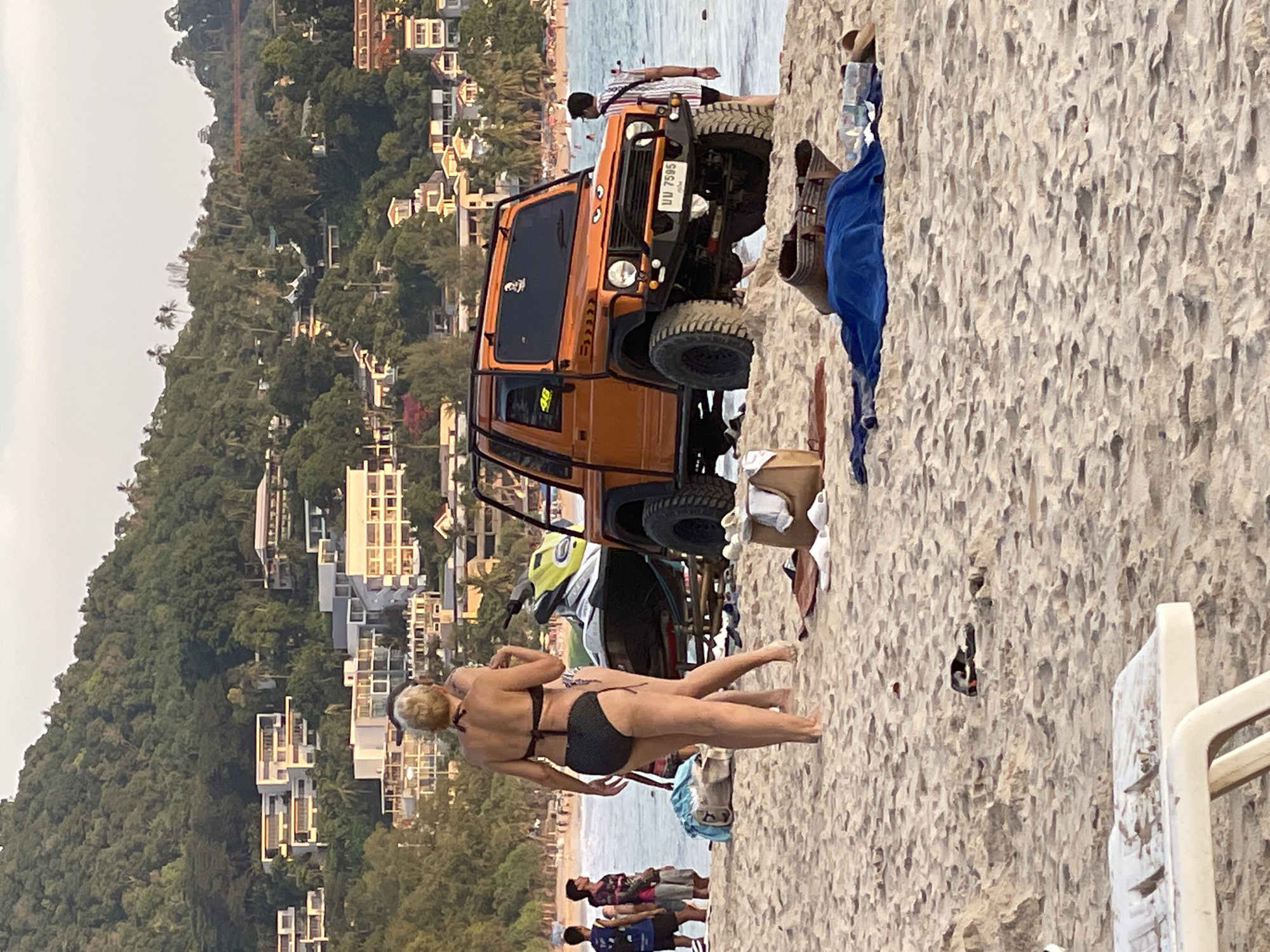 Tourists relax on Karon Beach facing Andaman Sea