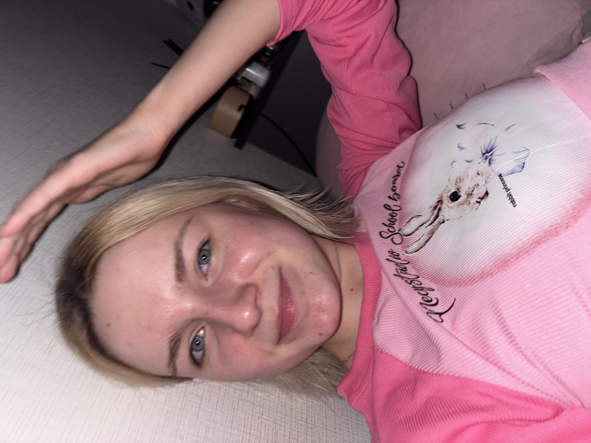 Woman in pink shirt observed indoors in Russia