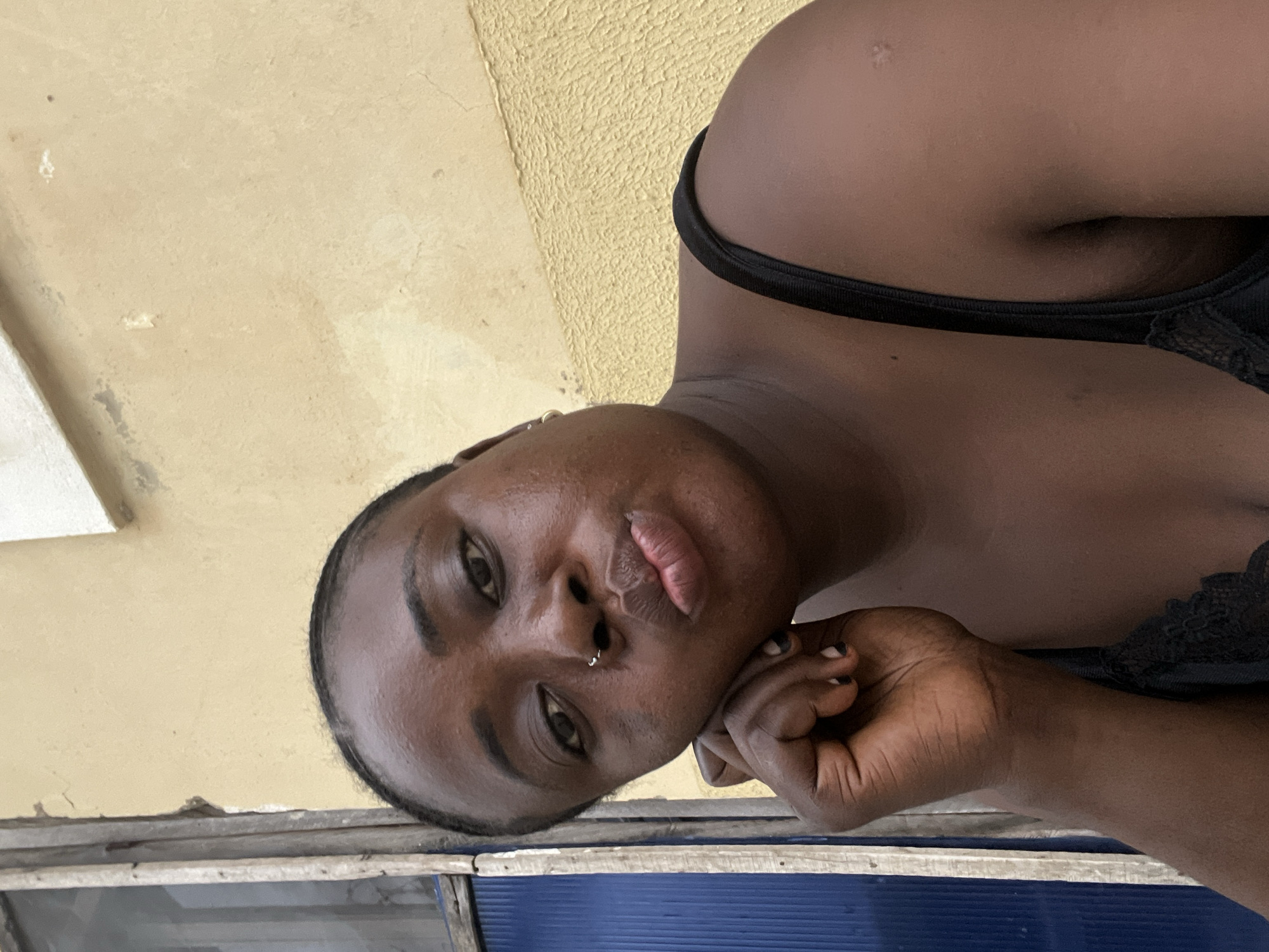 Woman photographed in multiple poses around Abuja residence