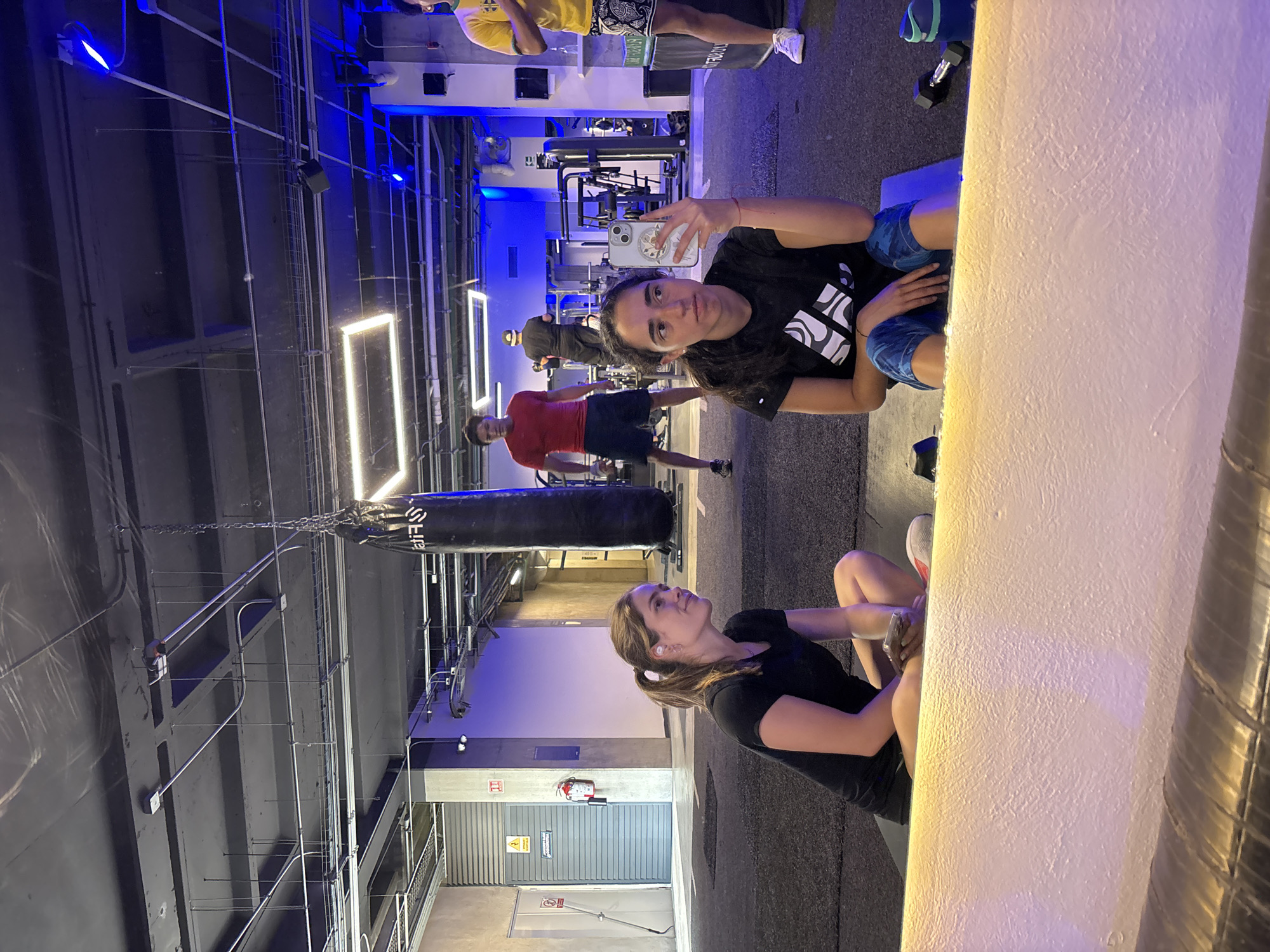 Gym selfie captures women and others during workout session