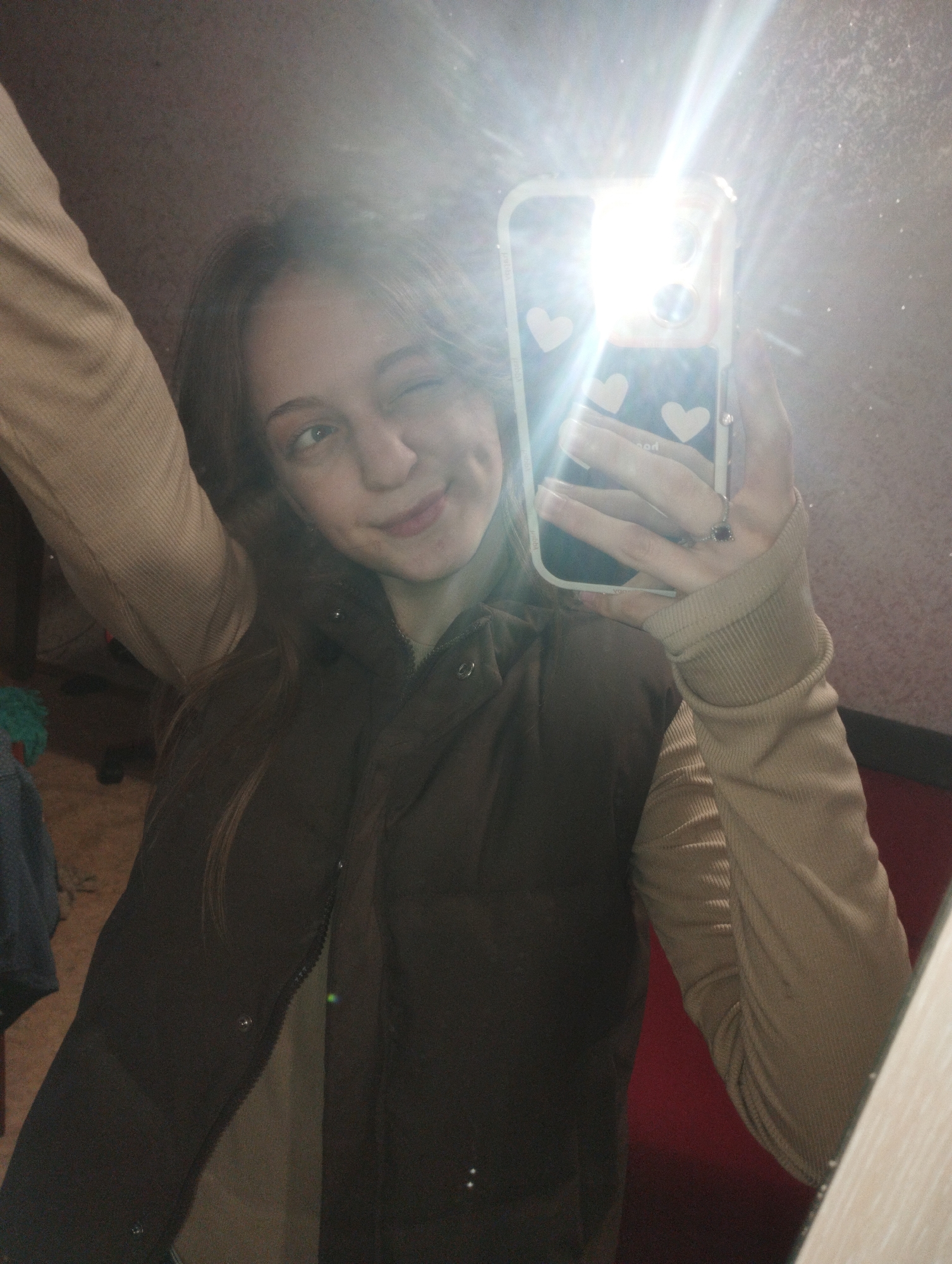 Young woman takes selfies in bedroom mirror in Saratov