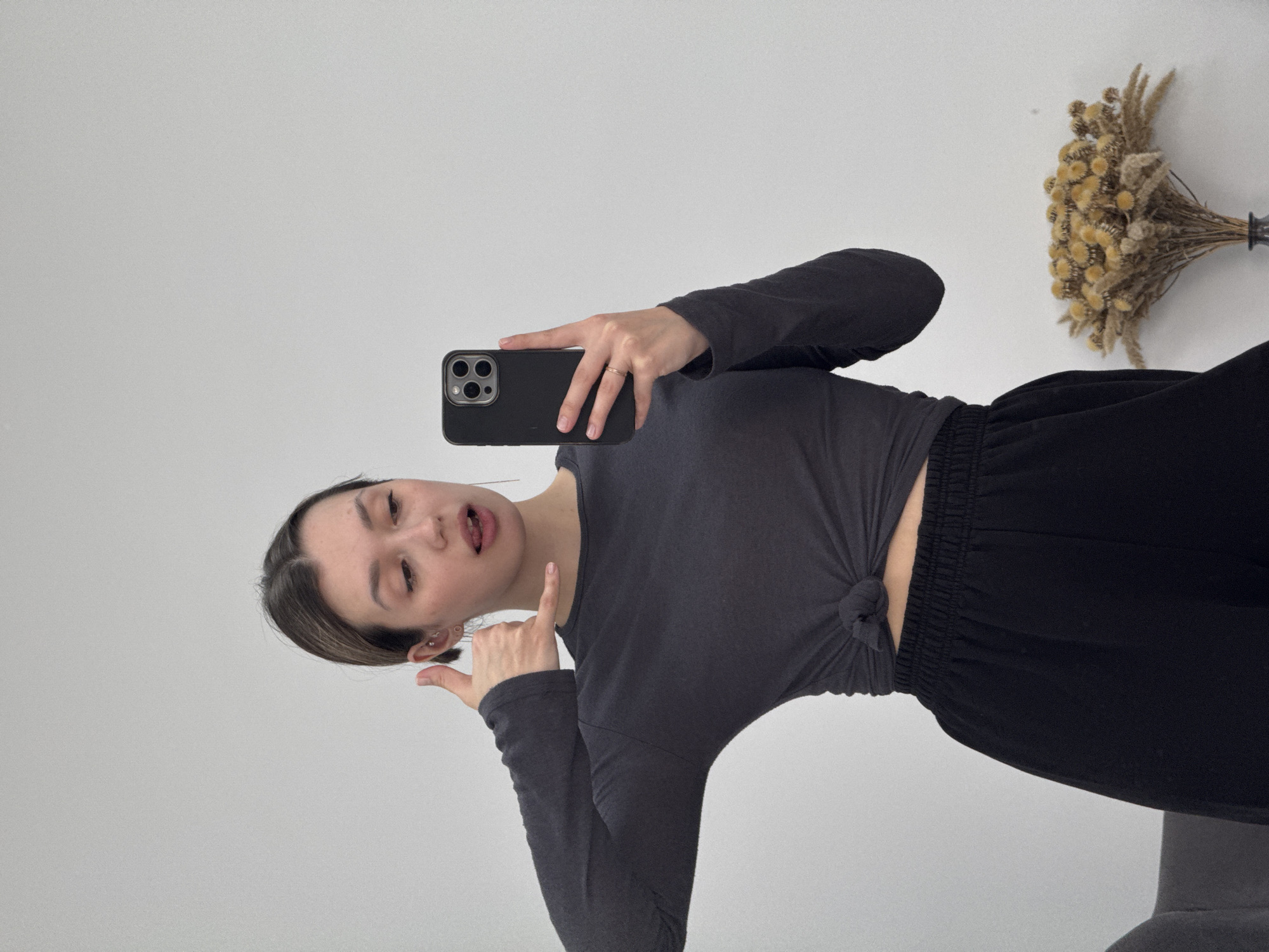 Woman Takes Horizontal Selfie in Dark Knotted Top