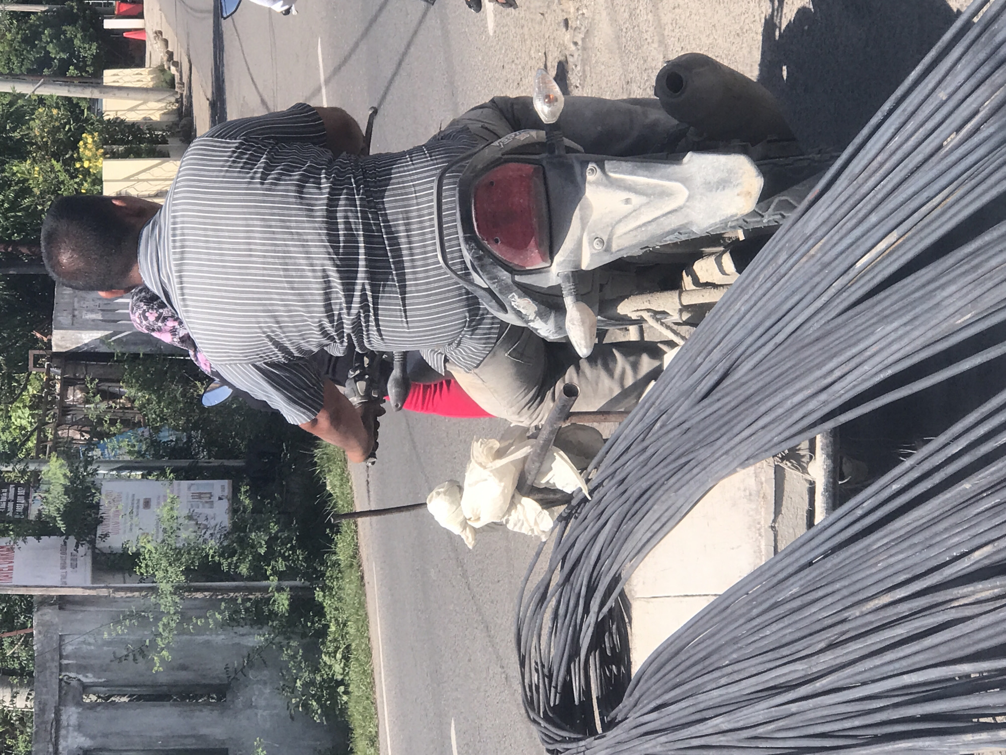 Motorcyclist transports steel bars in Lhokseumawe, Indonesia