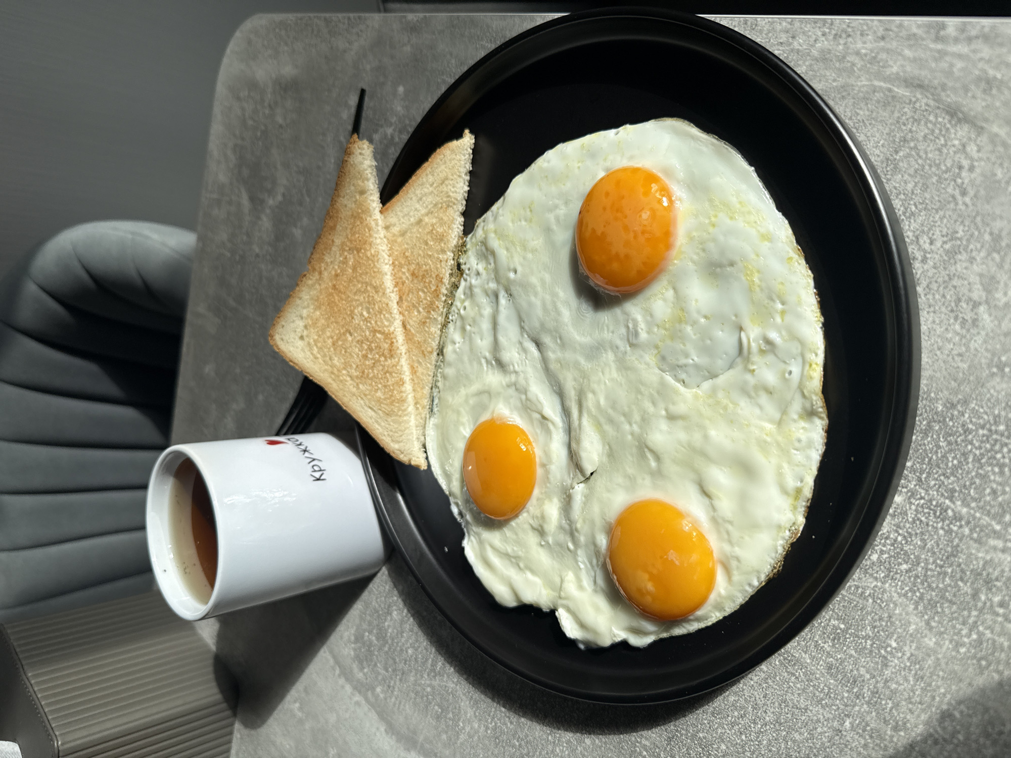 Breakfast documented in Lyubertsy: eggs, toast, dark beverage