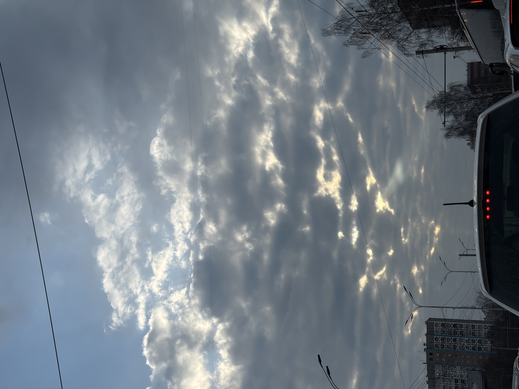 Sunlight breaks through gray clouds over Izhevsk, Russia
