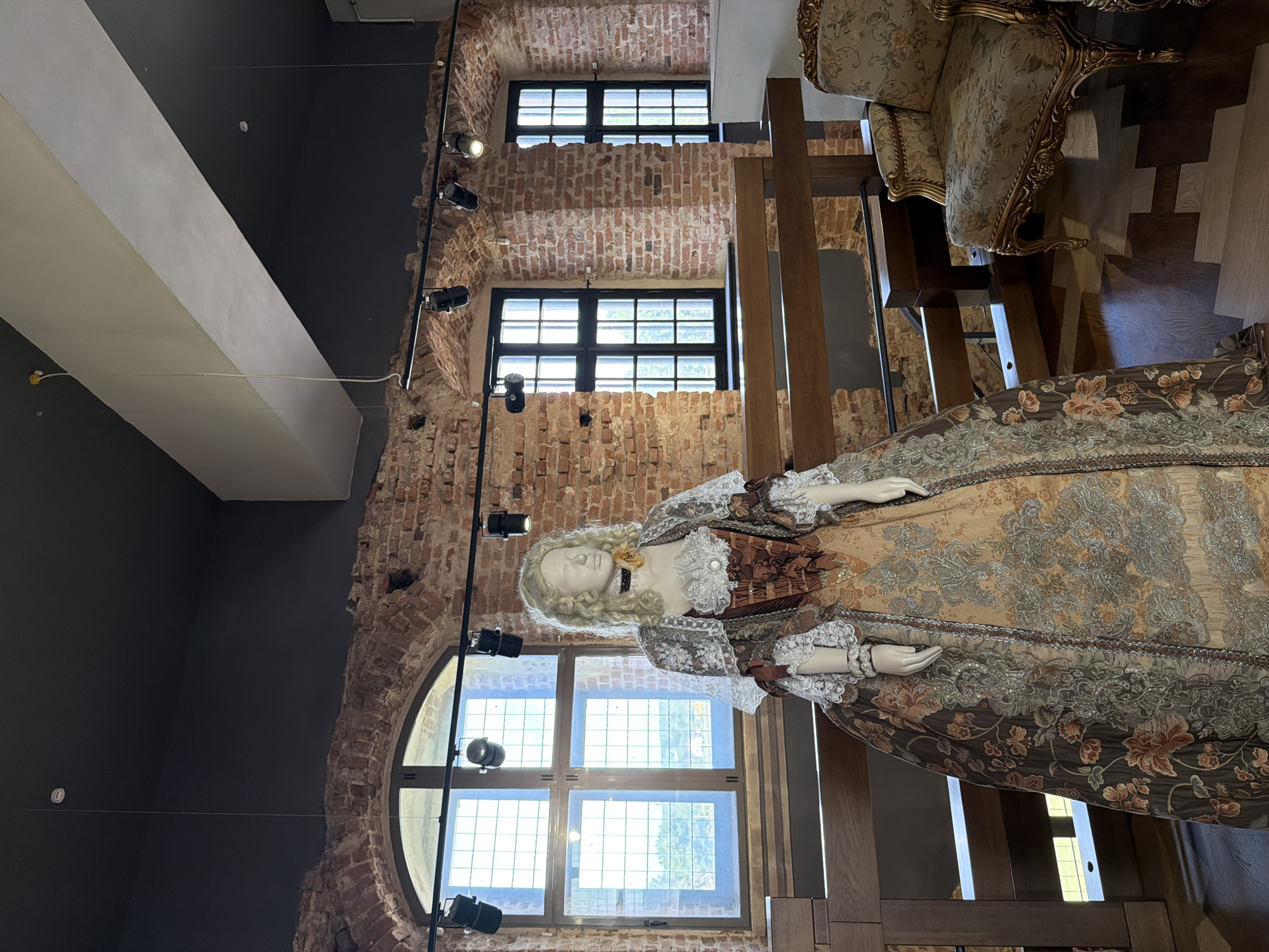 Inside a historic castle or palace museum with period rooms and armor