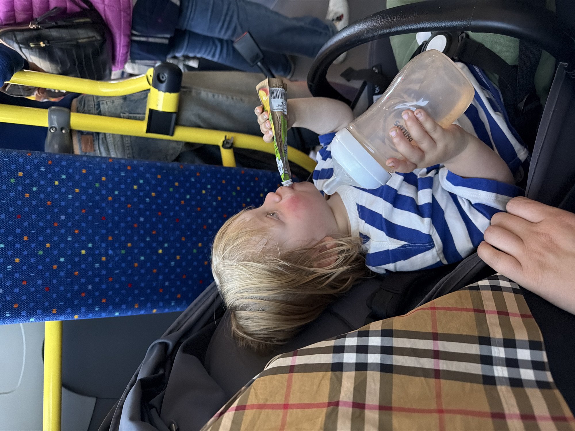 Child rests in stroller on public bus in northern Italy