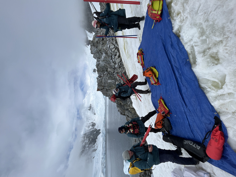 Group explores Antarctic coastline with inflatable boat near glacial waters