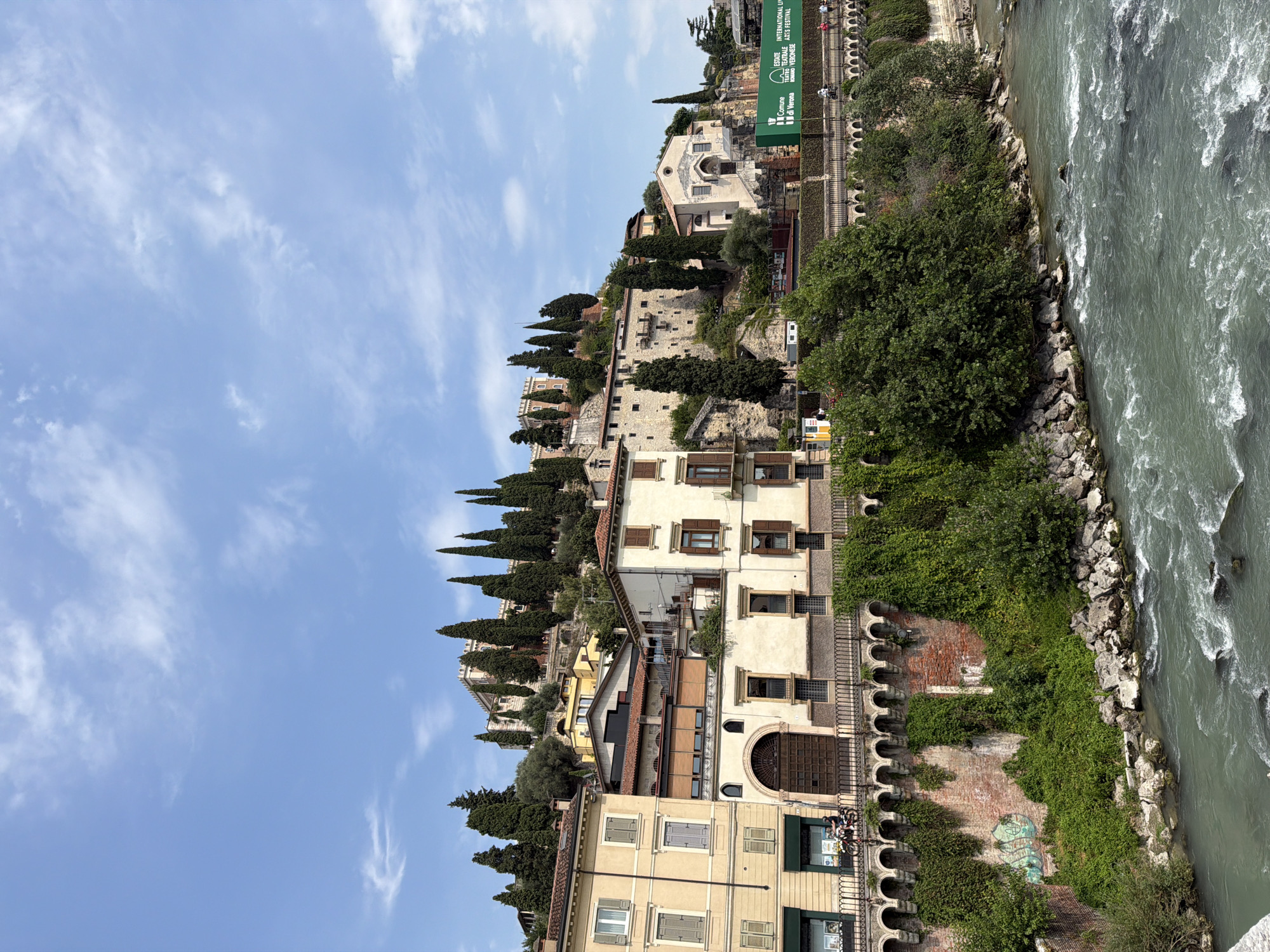 Adige River and Verona's historic riverfront on a summer afternoon