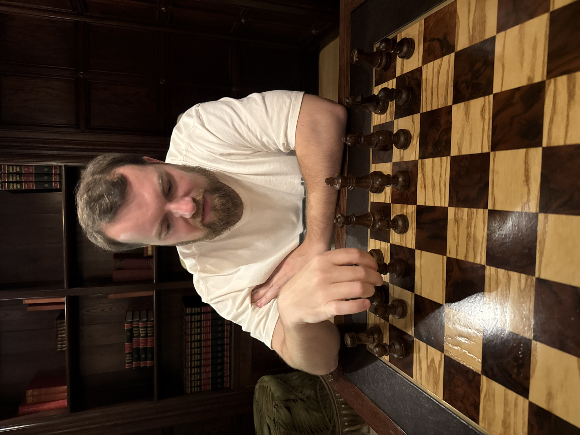 Cape Town evening: chess player indoors, wet restaurant tables outside