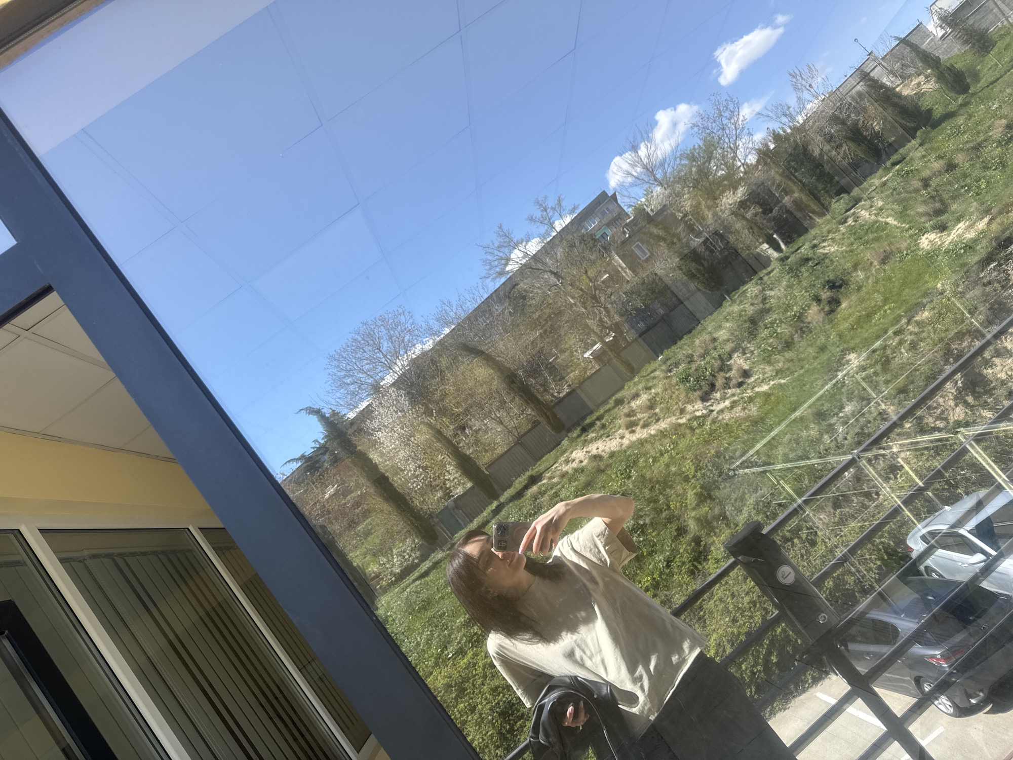 Woman takes selfies overlooking Tbilisi cityscape from building