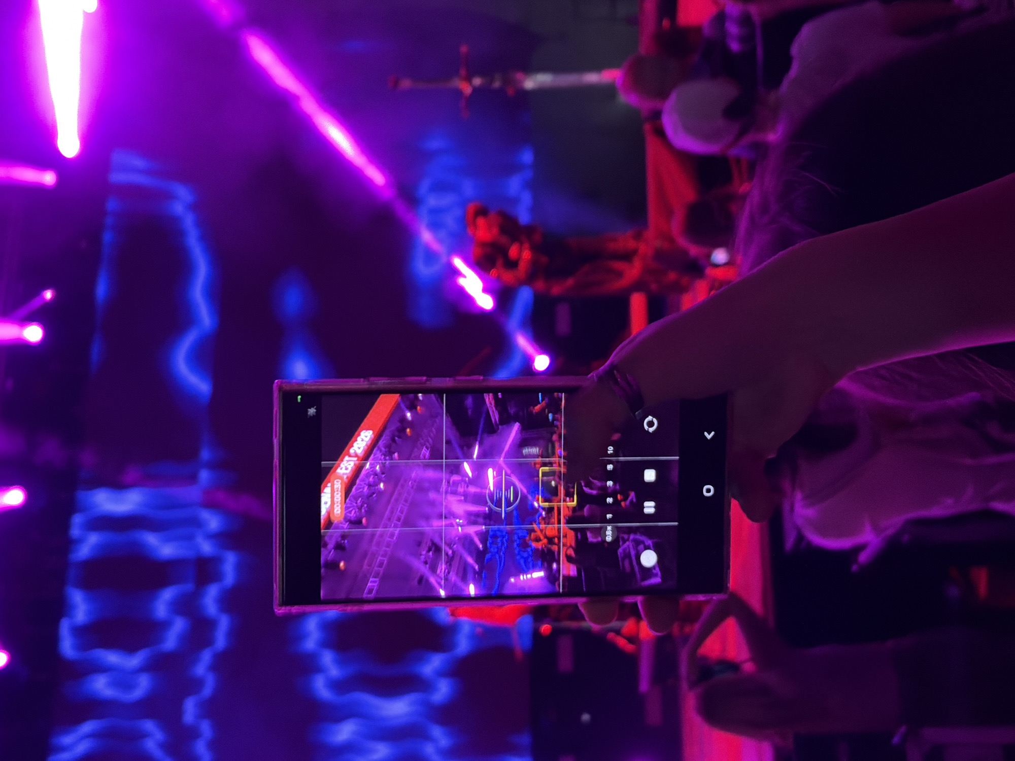 Live band plays a vibrant, light-soaked outdoor night concert