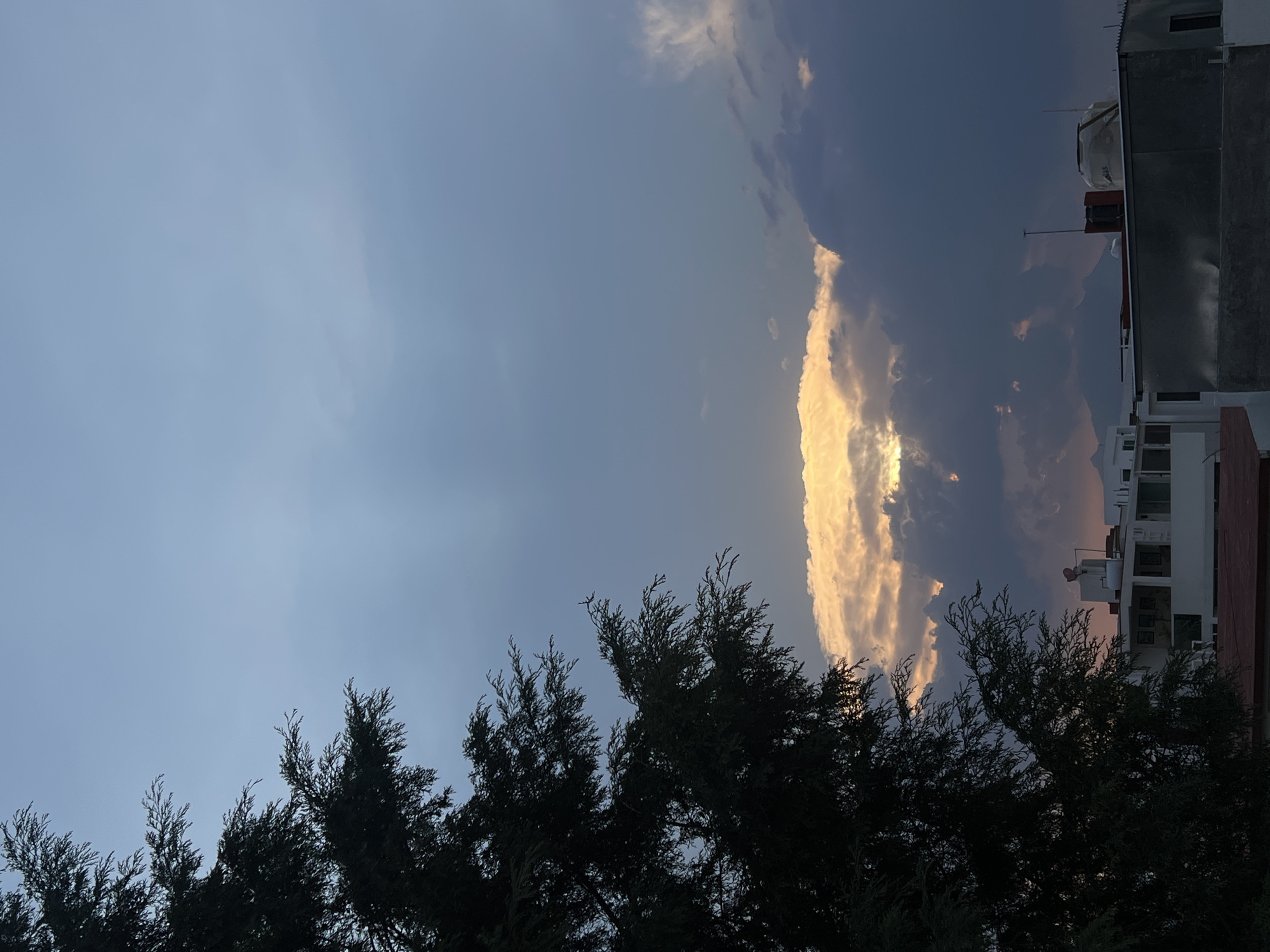 Golden sunlight illuminates dramatic cloud formation over Cholula, Mexico
