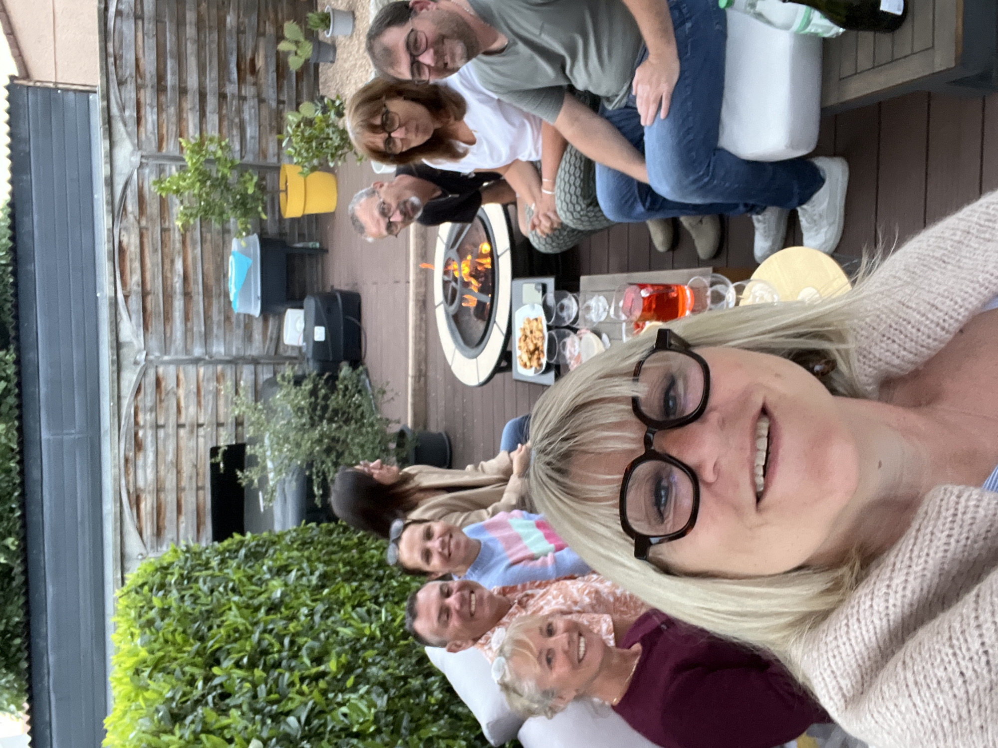Eight gather around fire pit with drinks in Veauche