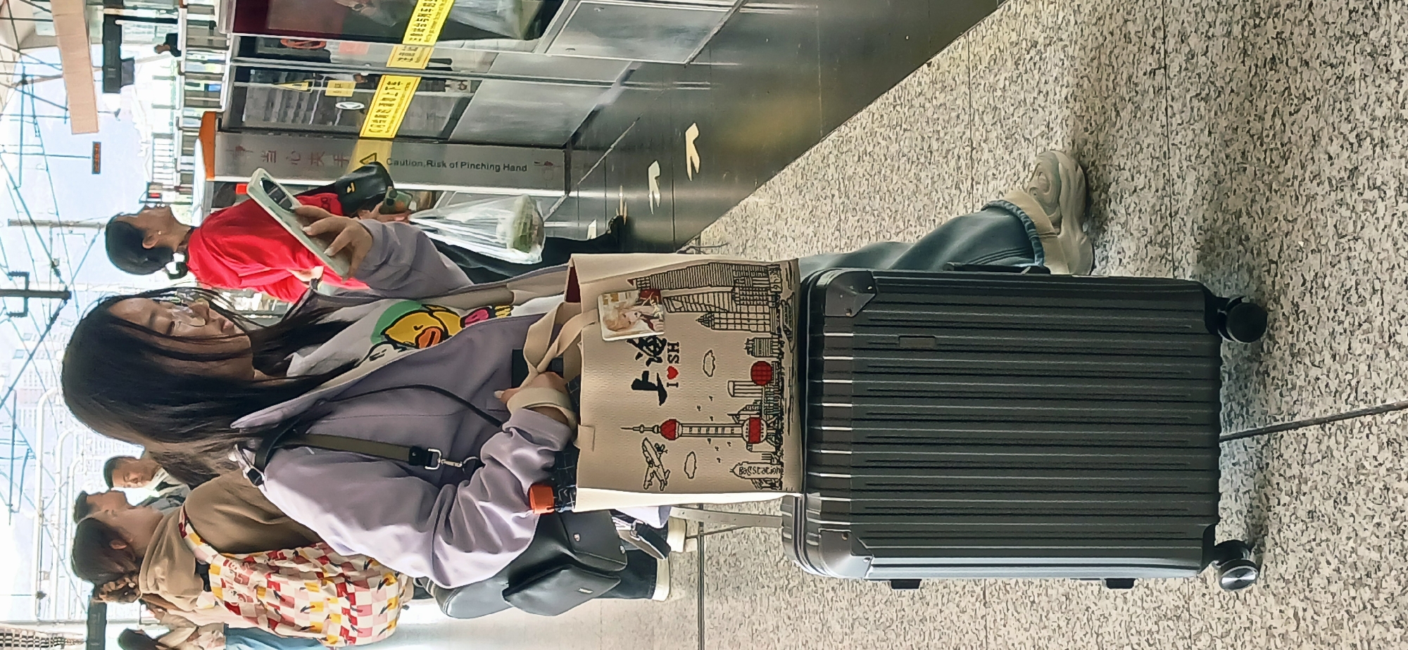 Woman uses phone at Chongqing railway station