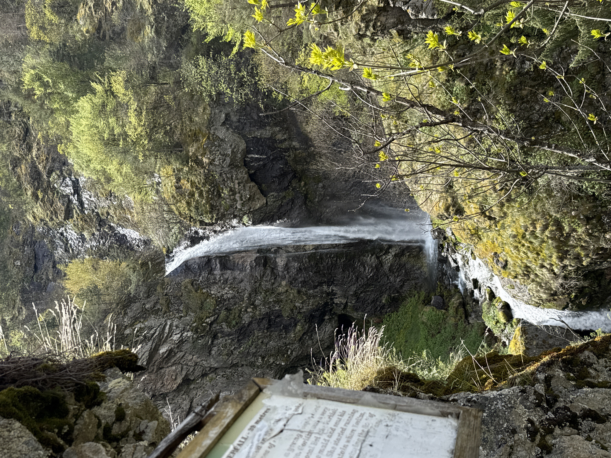 Tourists photograph at Bulgarian waterfall during spring visit