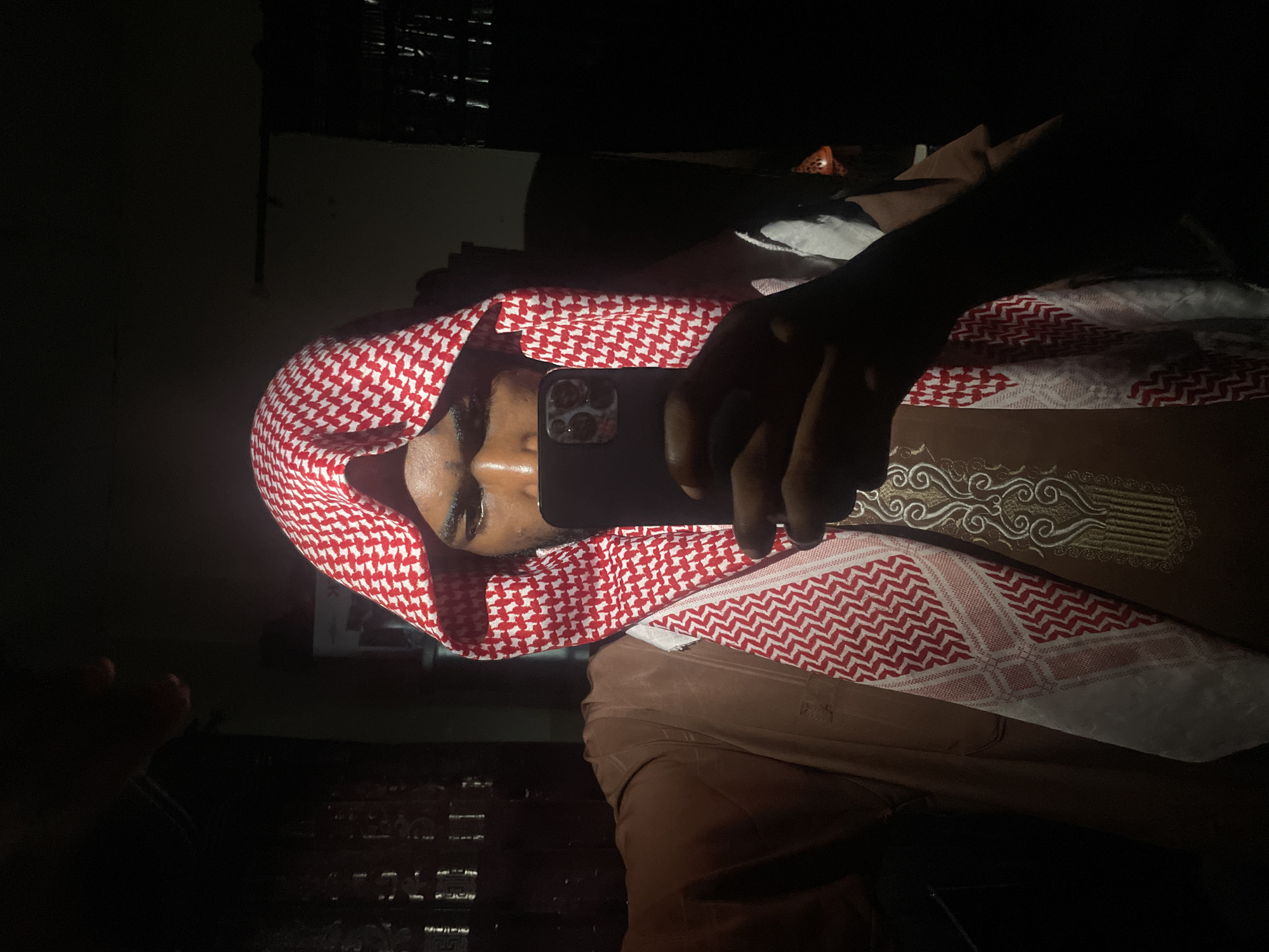 Person takes smartphone selfies in traditional dress, Lokoja Nigeria