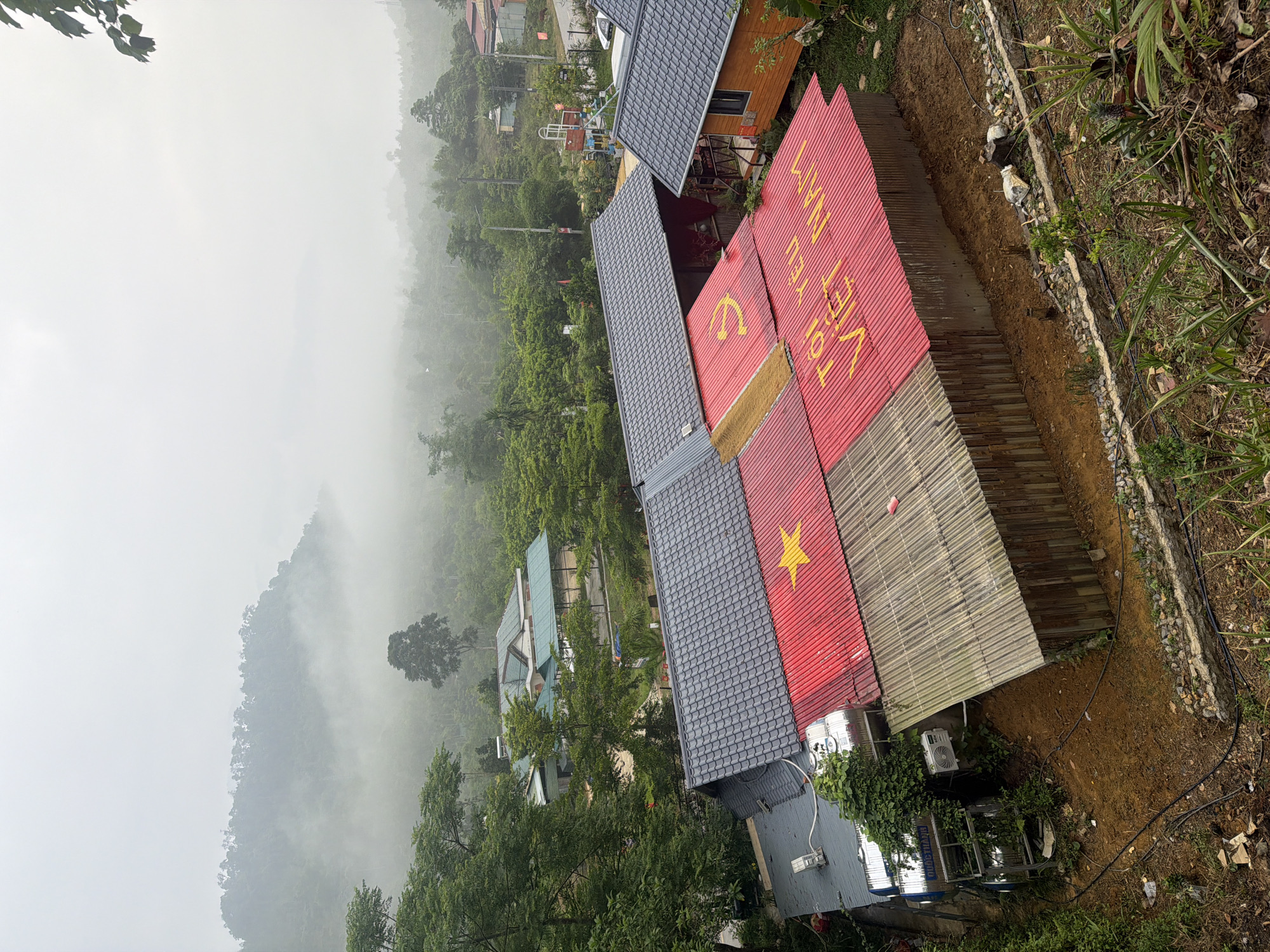 Hillside buildings with red roofs photographed in Da Nang