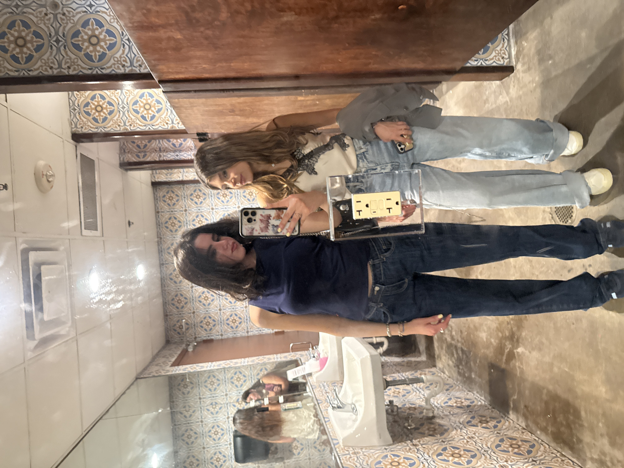 Two women take selfie in College Station public restroom