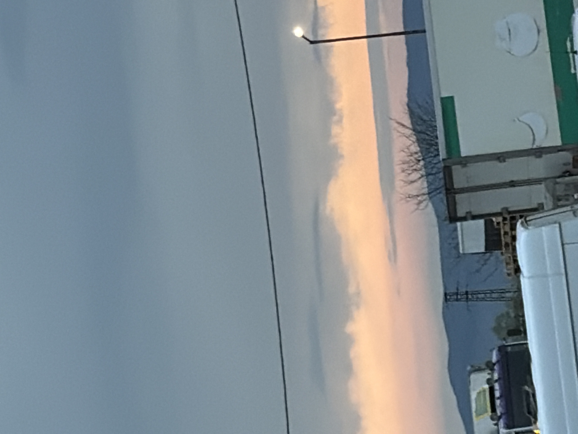 Sunrise or sunset sky captured over industrial landscape