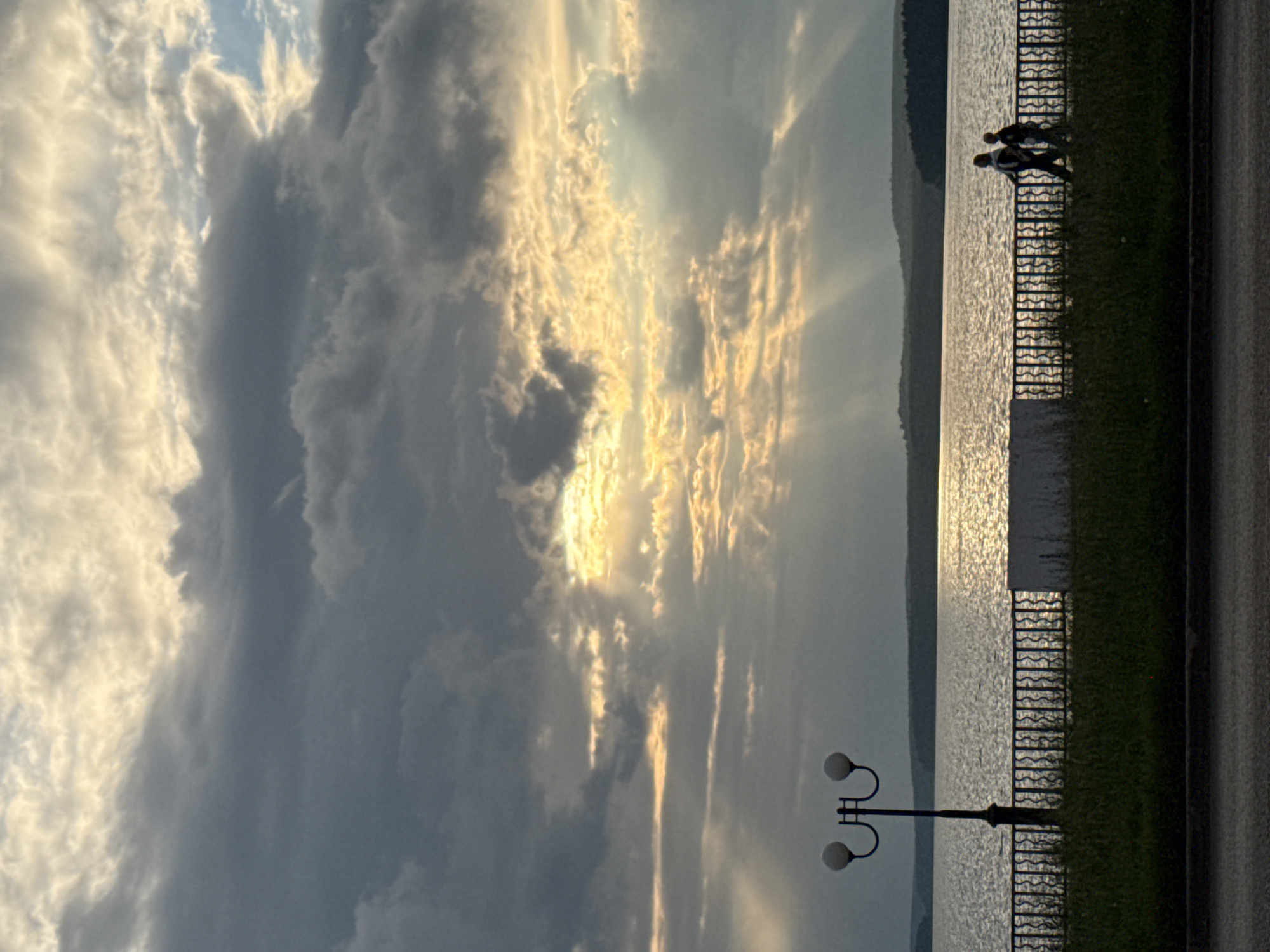 Golden sunset over Votkinsk waterfront, clouds and a cat