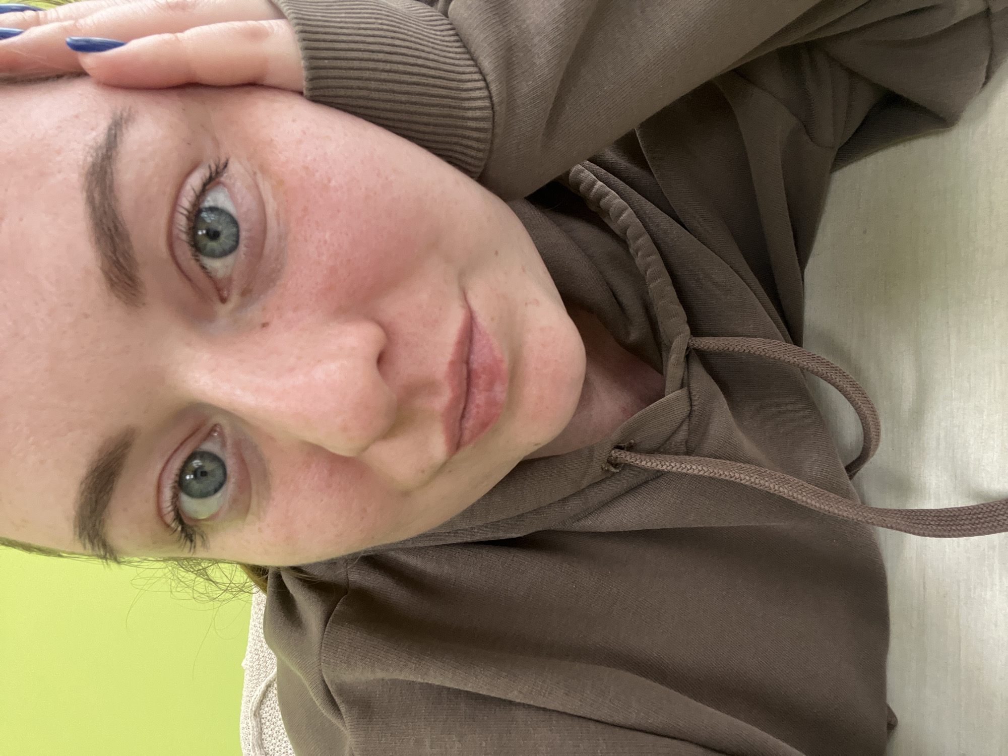 Woman takes mirror selfies with watering can in Klin