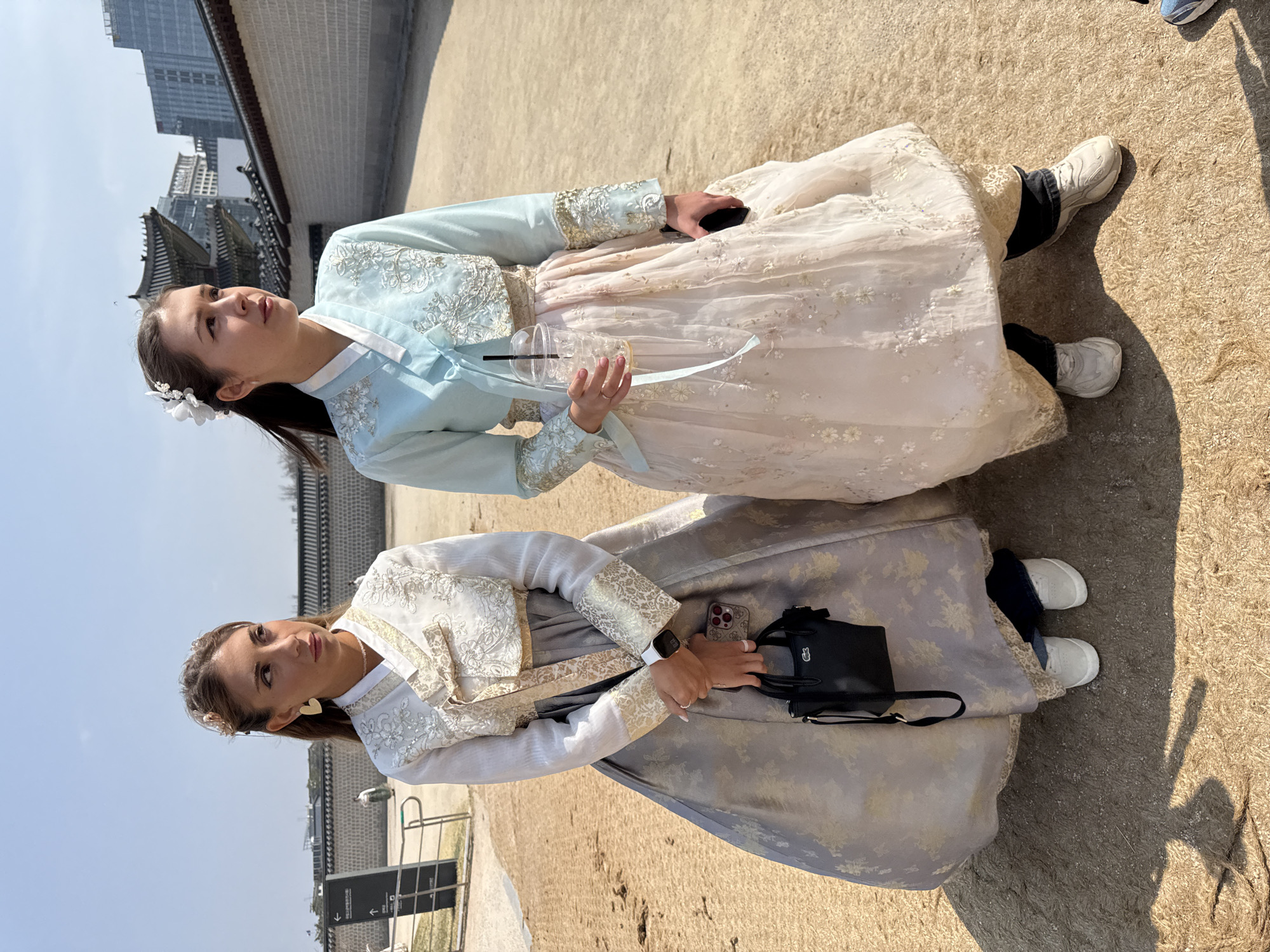 Tourists in traditional Korean dress visit Gyeongbokgung Palace