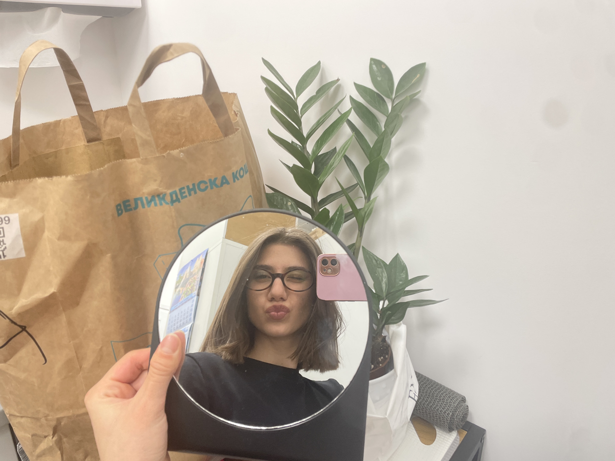 Woman tries on glasses at Sofia eyewear store