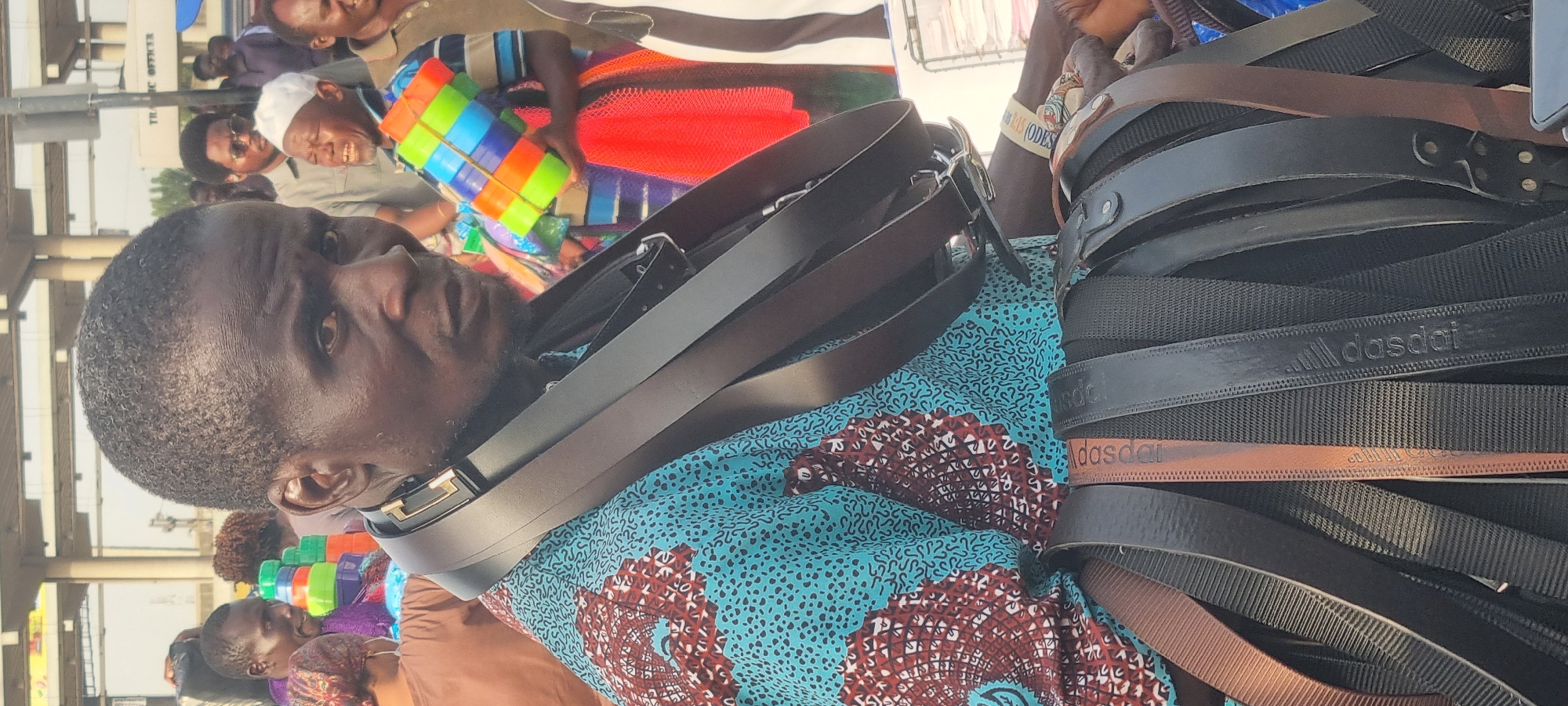 Street vendor sells counterfeit belts in busy Ikeja market