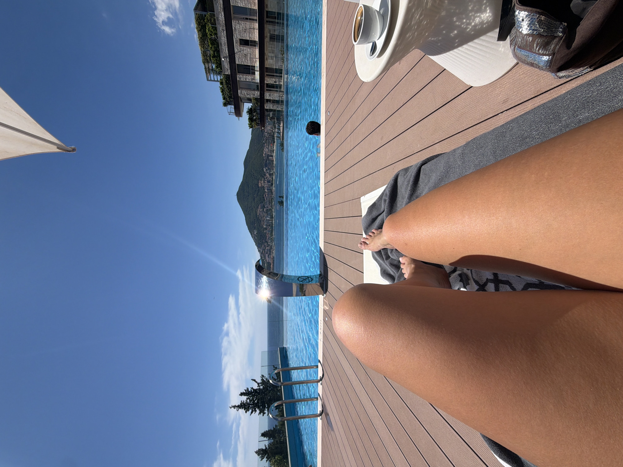 Poolside relaxation at Montenegro infinity pool overlooking Adriatic Sea