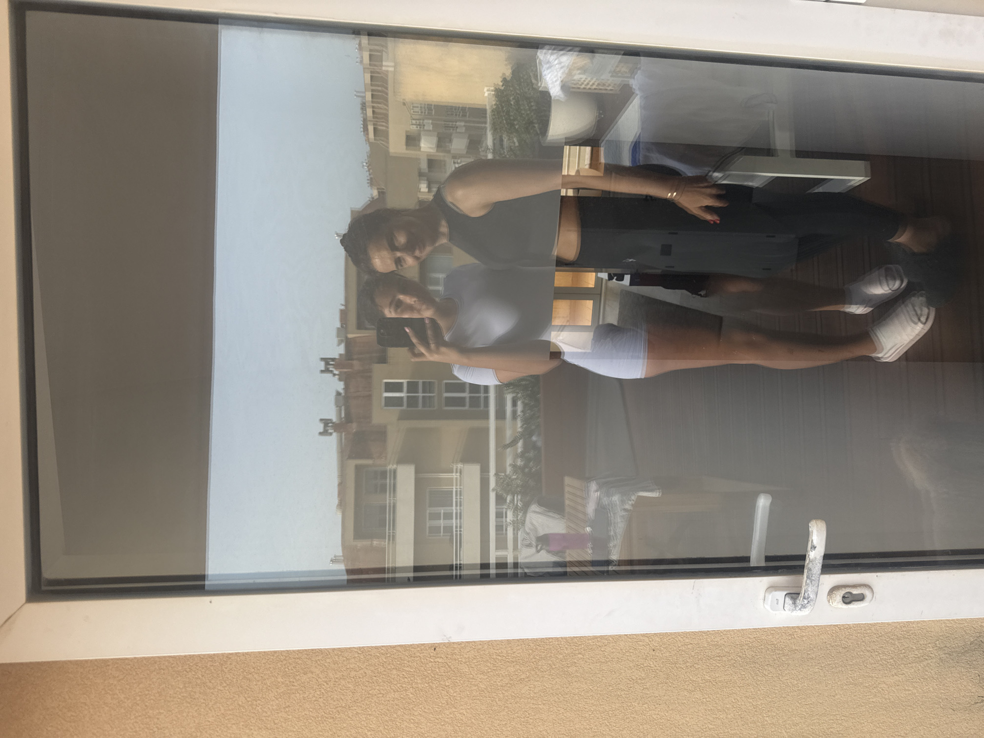 Two women reflected in glass door, Vila Nova de Gaia