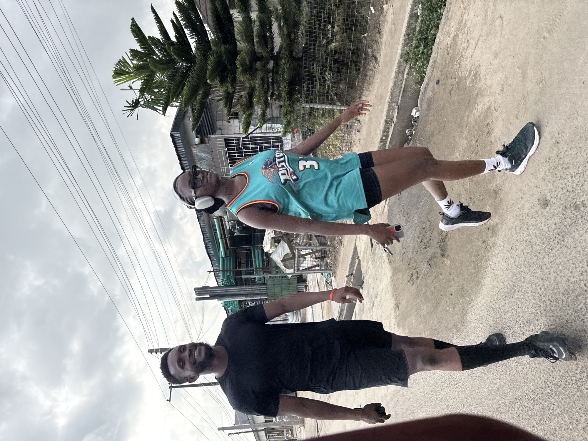 Young men pose for photos on Ado street