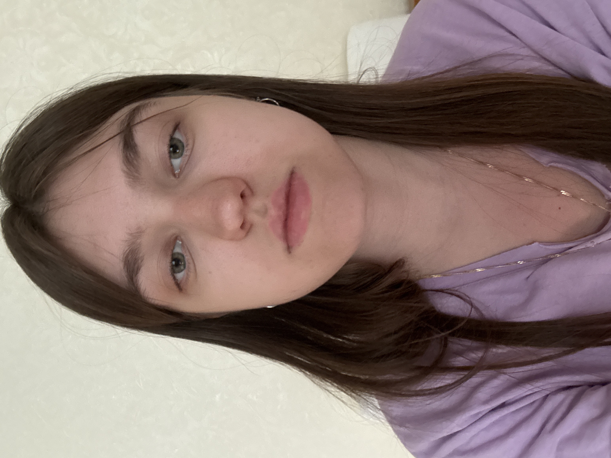 Woman in purple shirt photographed multiple times in bedroom