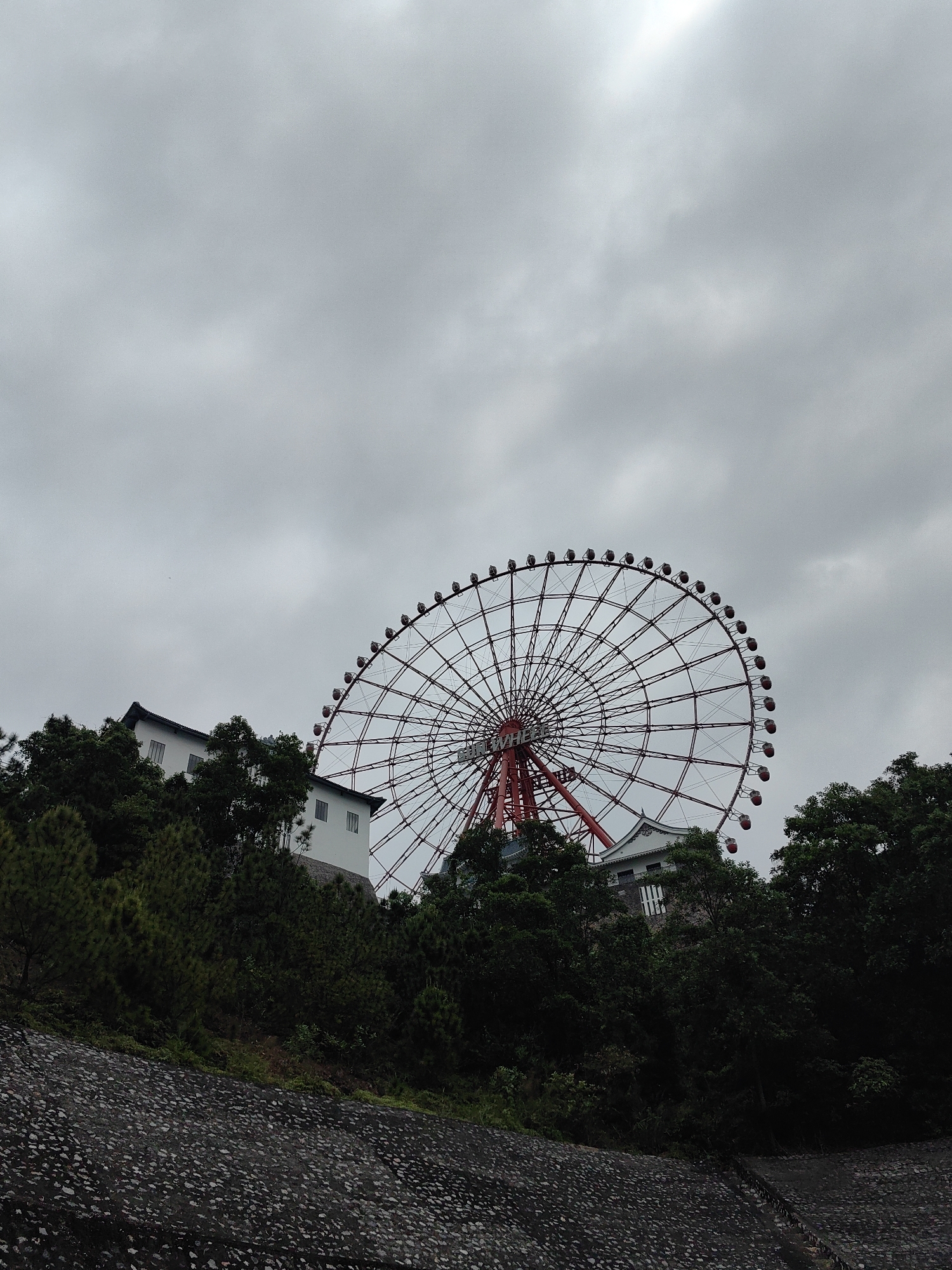 Red Ferris wheel spotted on hillside in Hong Gai Ward