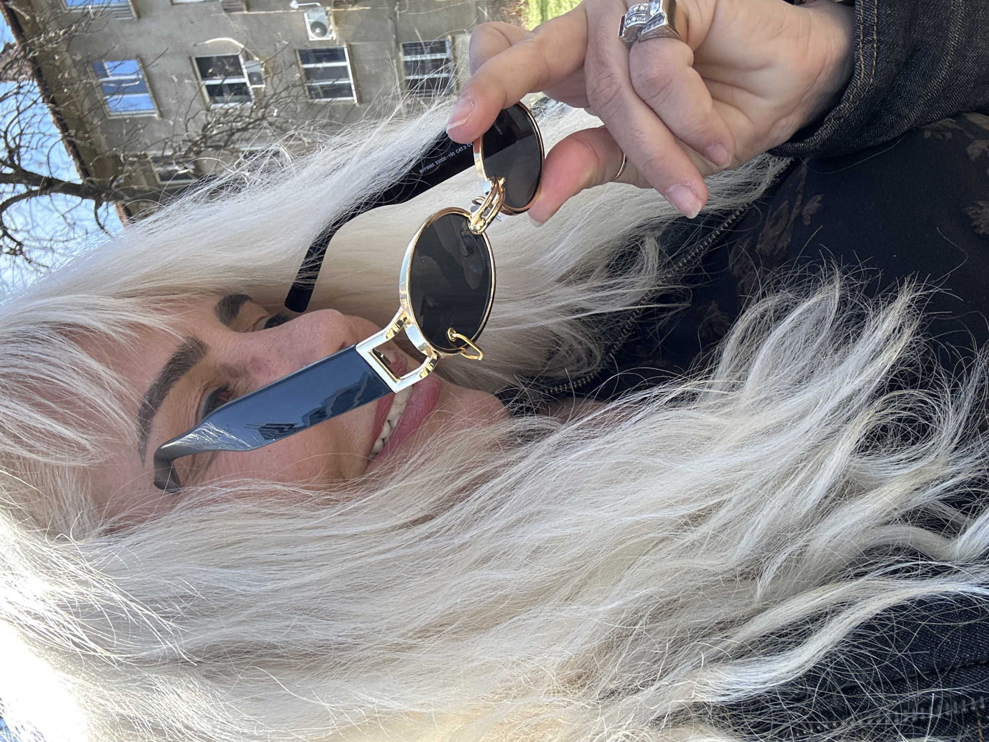 Woman holds designer sunglasses in Sofia, Bulgaria