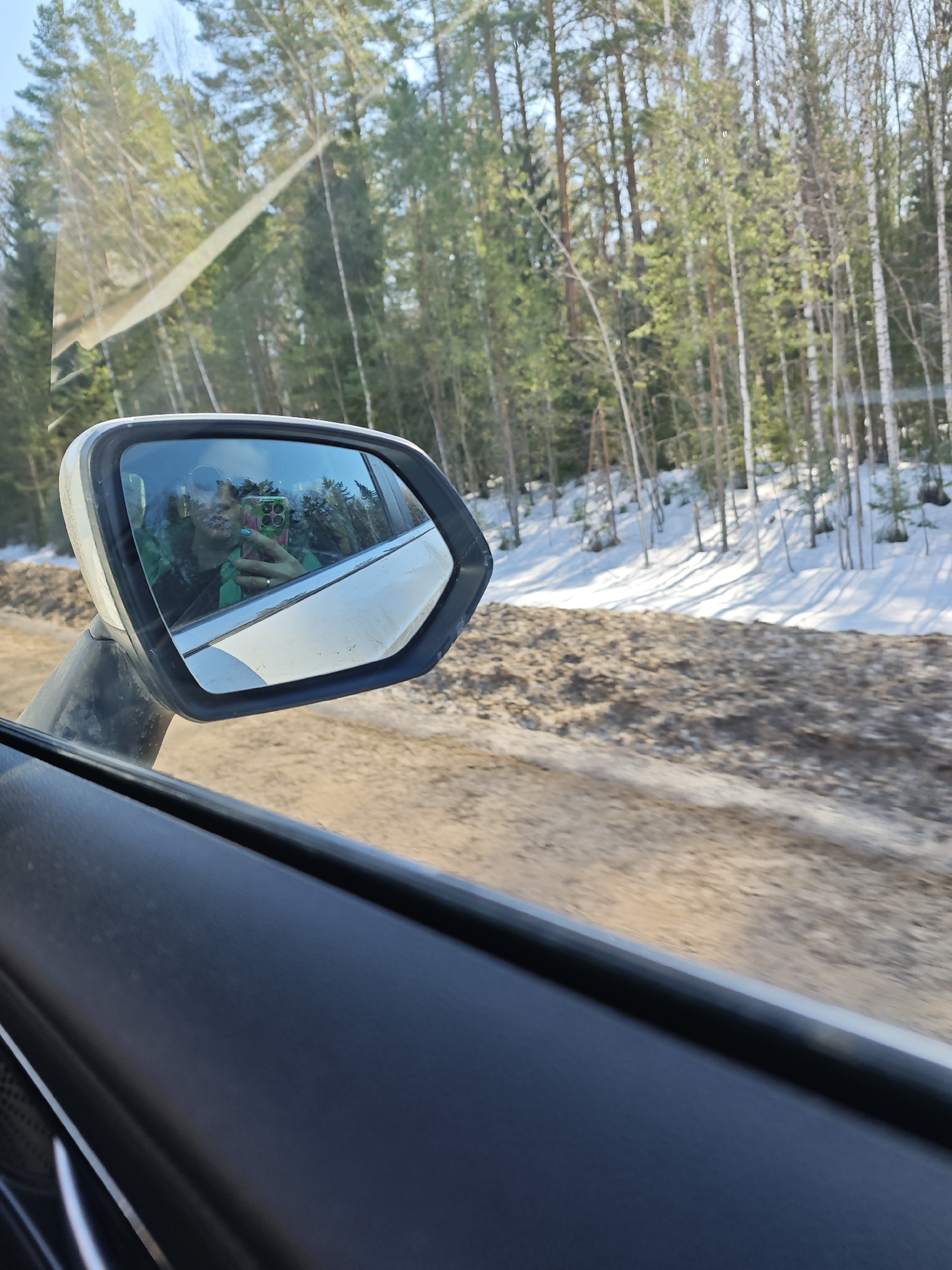 Woman takes car selfie on Russian dirt road
