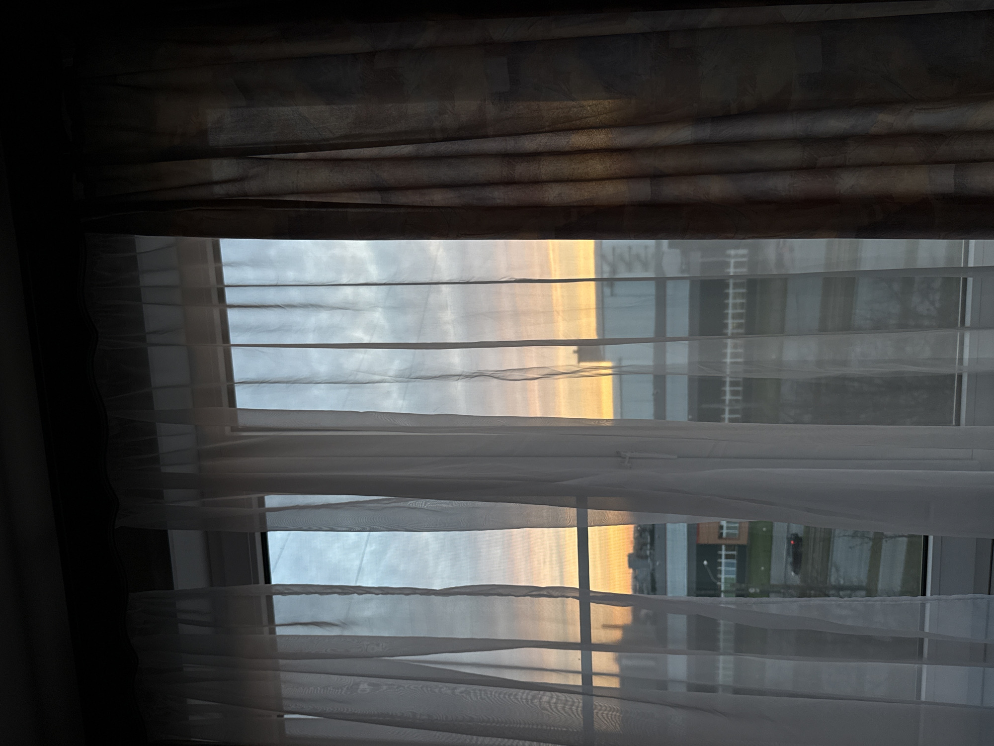 Resident captures sunset cityscape views through window in Saint Petersburg