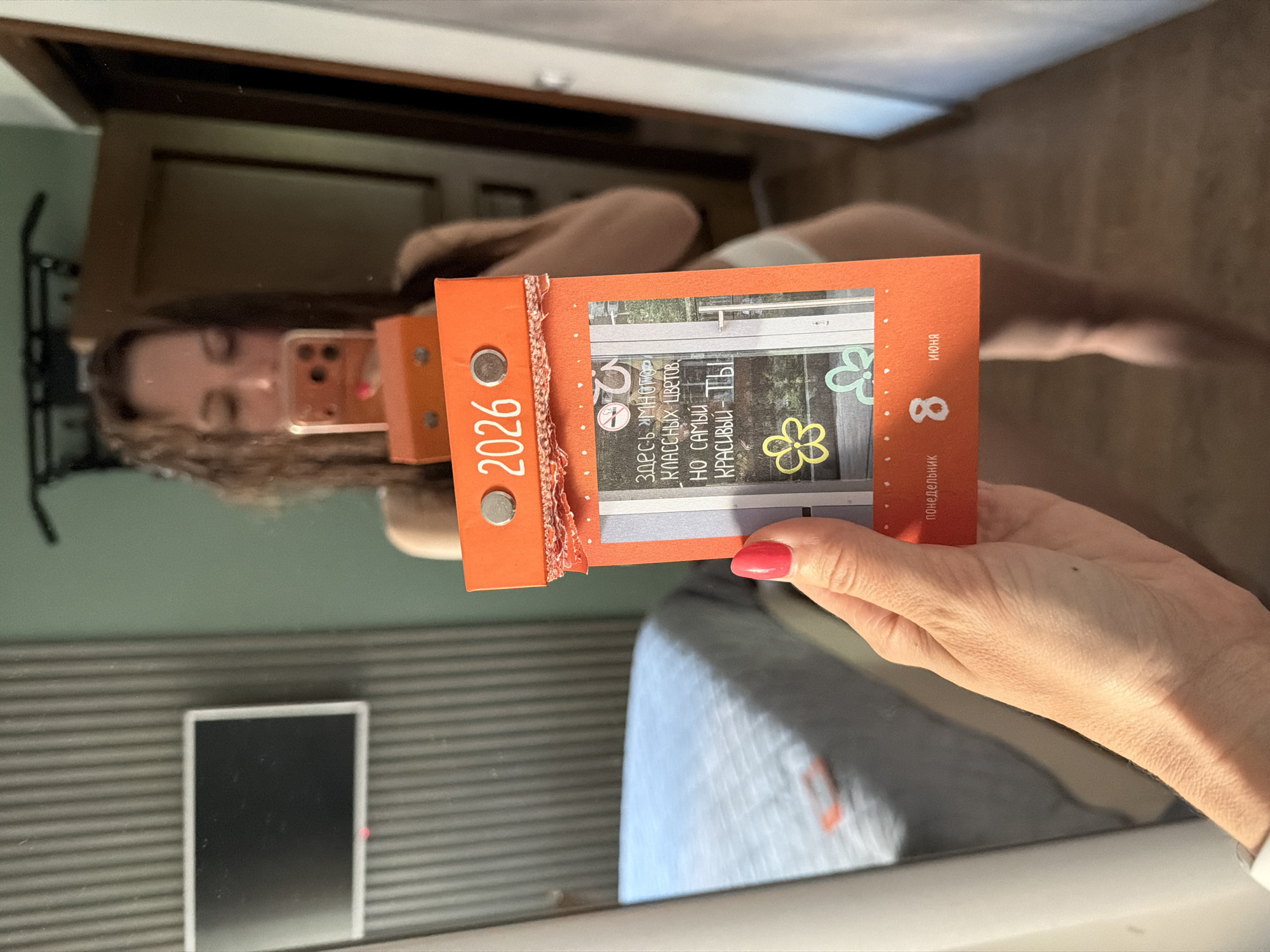 Woman takes mirror selfies with calendar in Birobidzhan bedroom