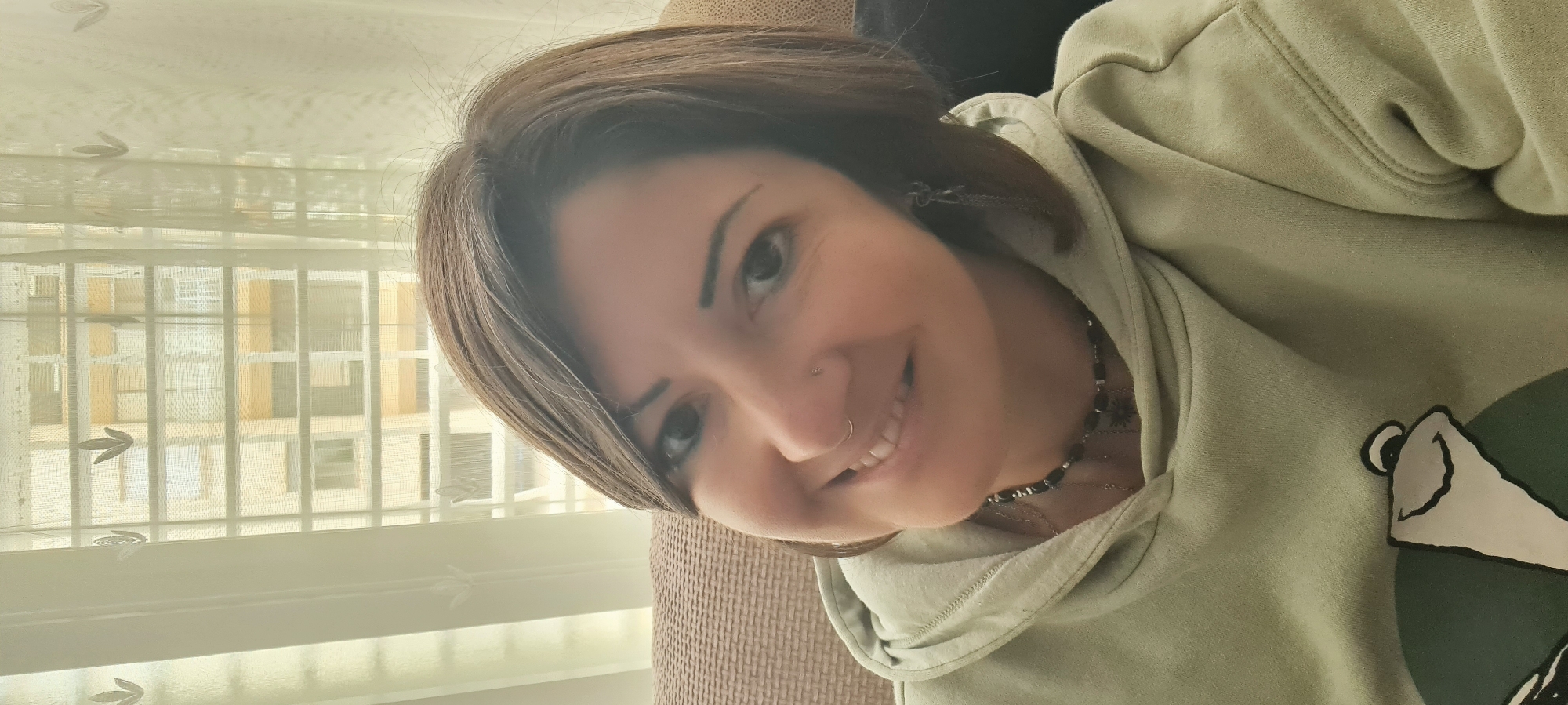 Woman takes selfies indoors in Nahariyya, Israel