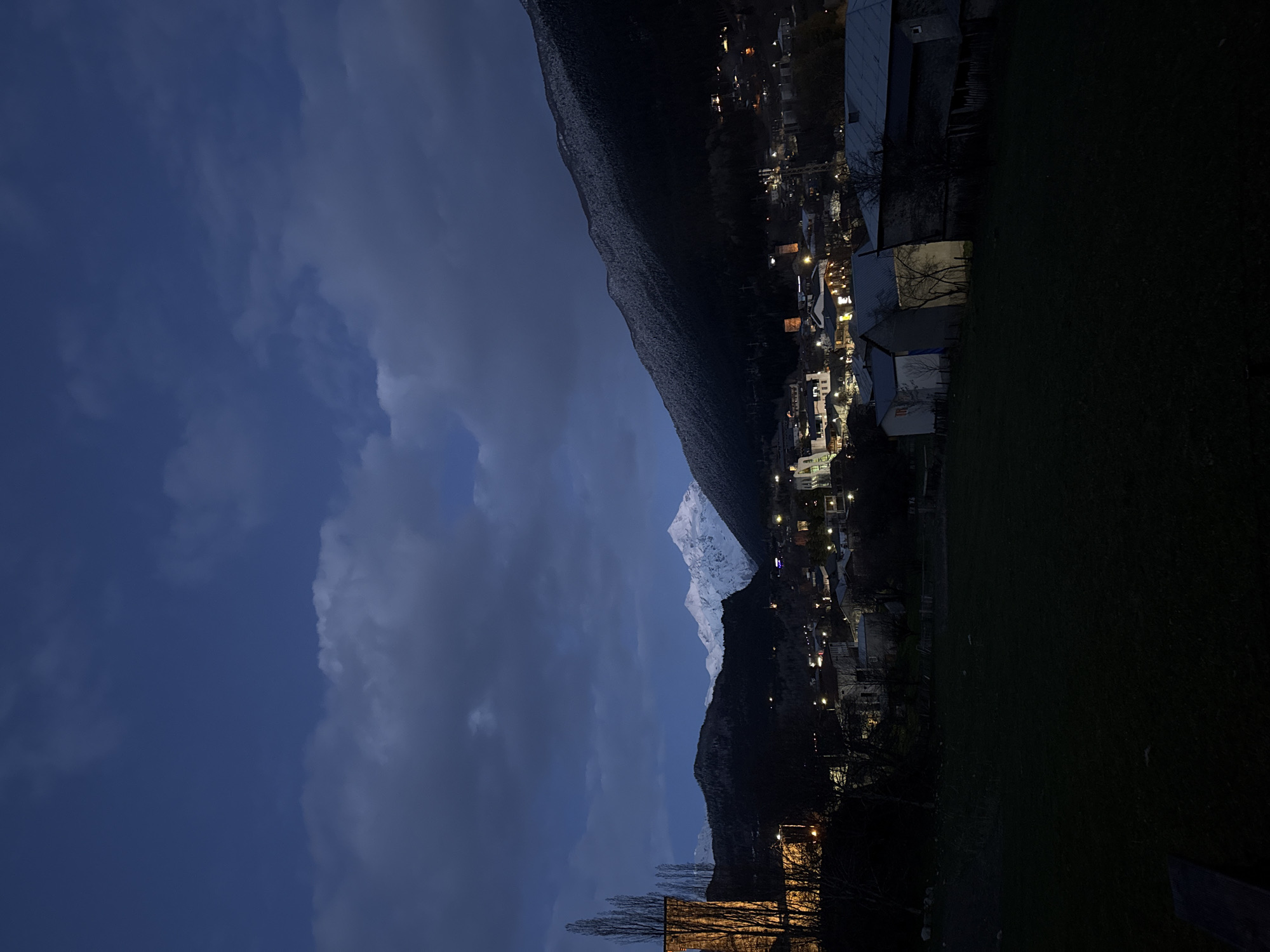 Moonlit snow peaks illuminate Mestia town at night