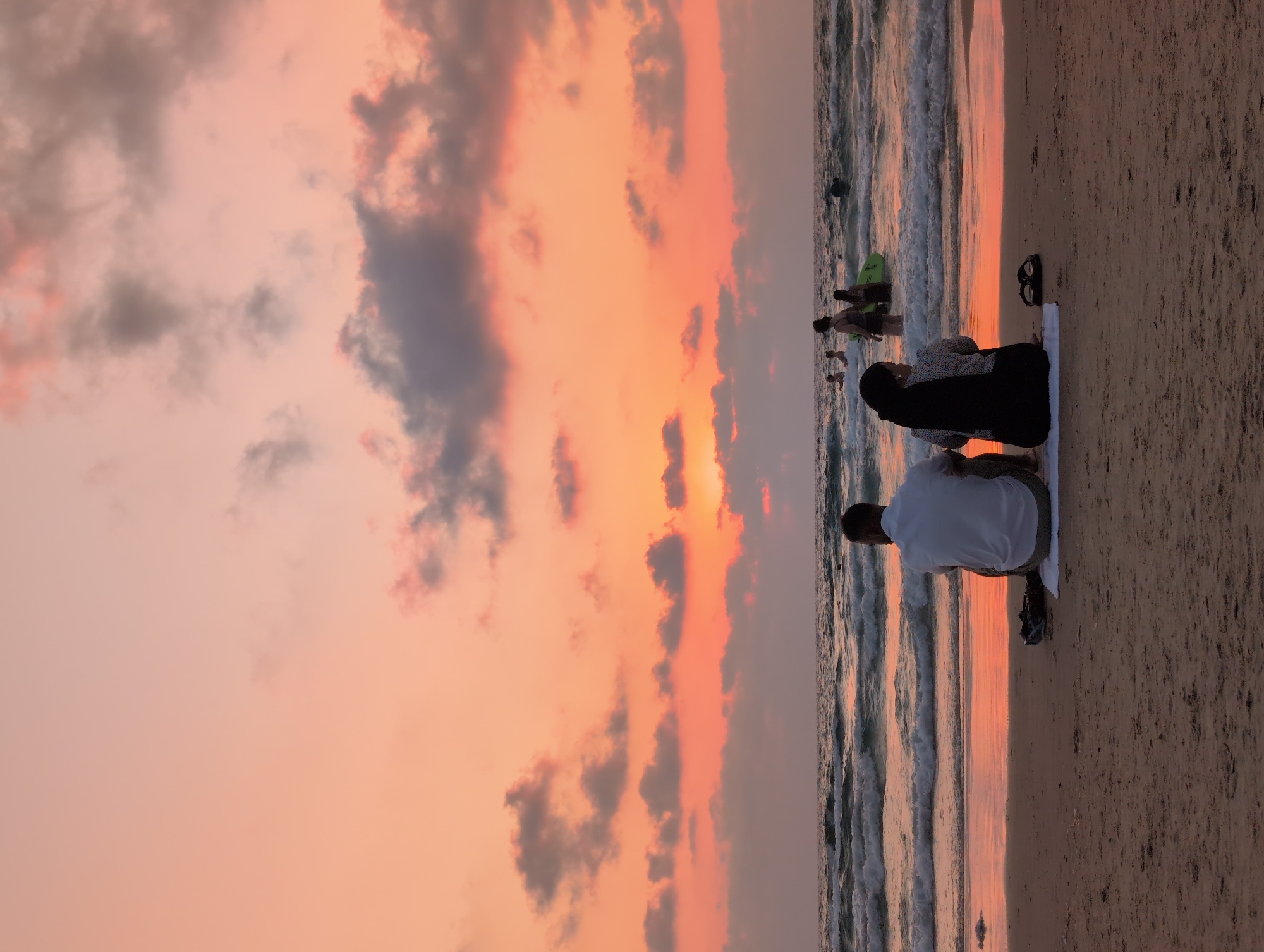 Golden hour on the Bat Yam shoreline, chairs facing the sea.