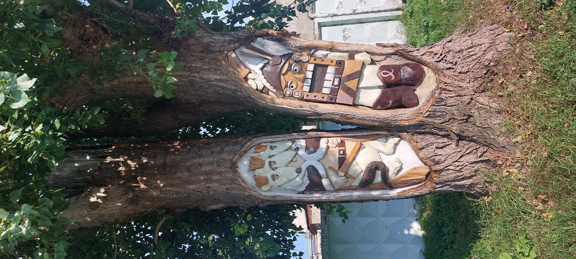 Chaikovsky's outdoor murals and wood carvings, mid-summer