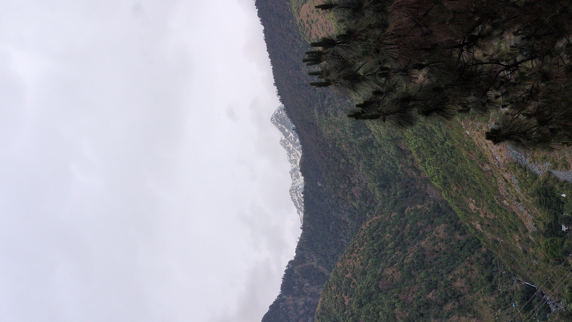 Mountain landscape photographed in Bhagsu, India under overcast skies