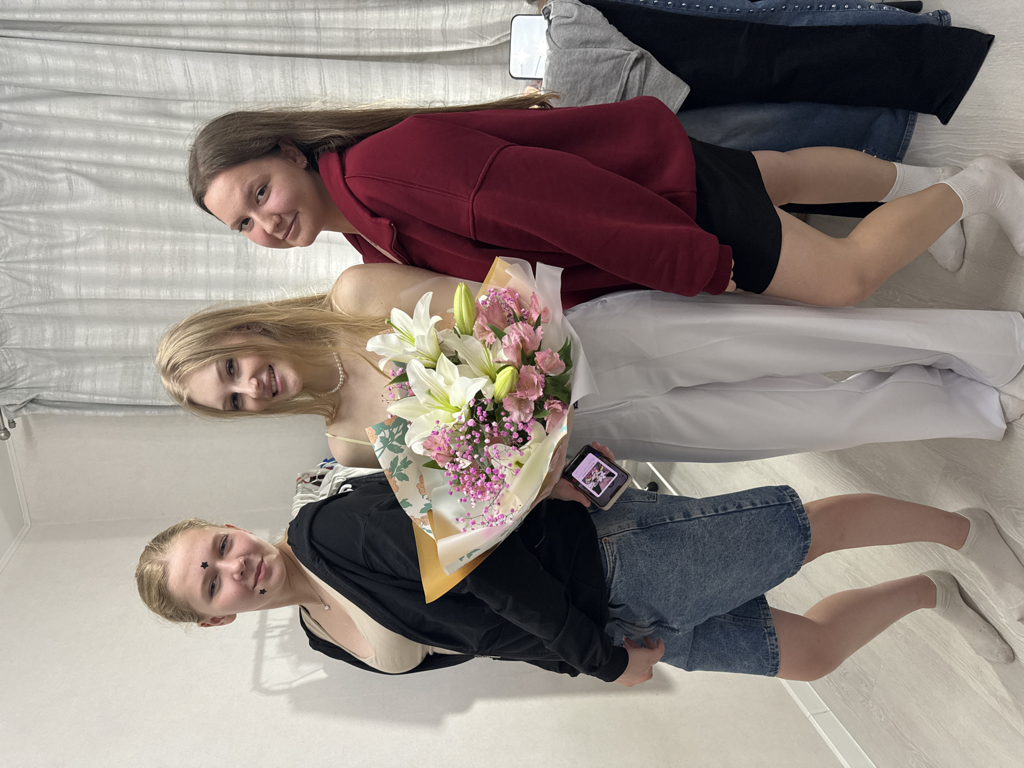 Friends celebrate with lilies and alstroemeria in a Perm bedroom