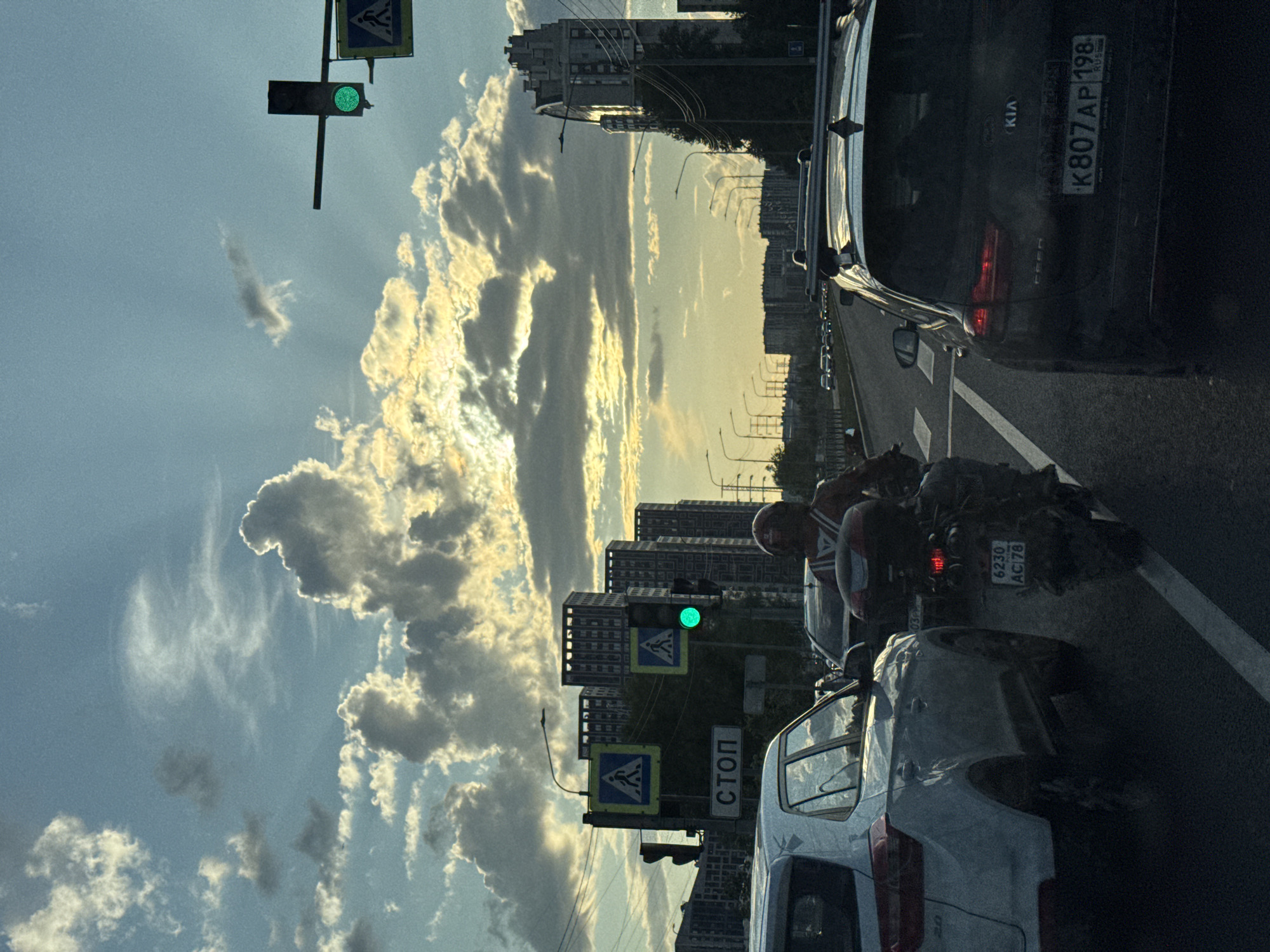Saint Petersburg traffic under a golden late-afternoon sky