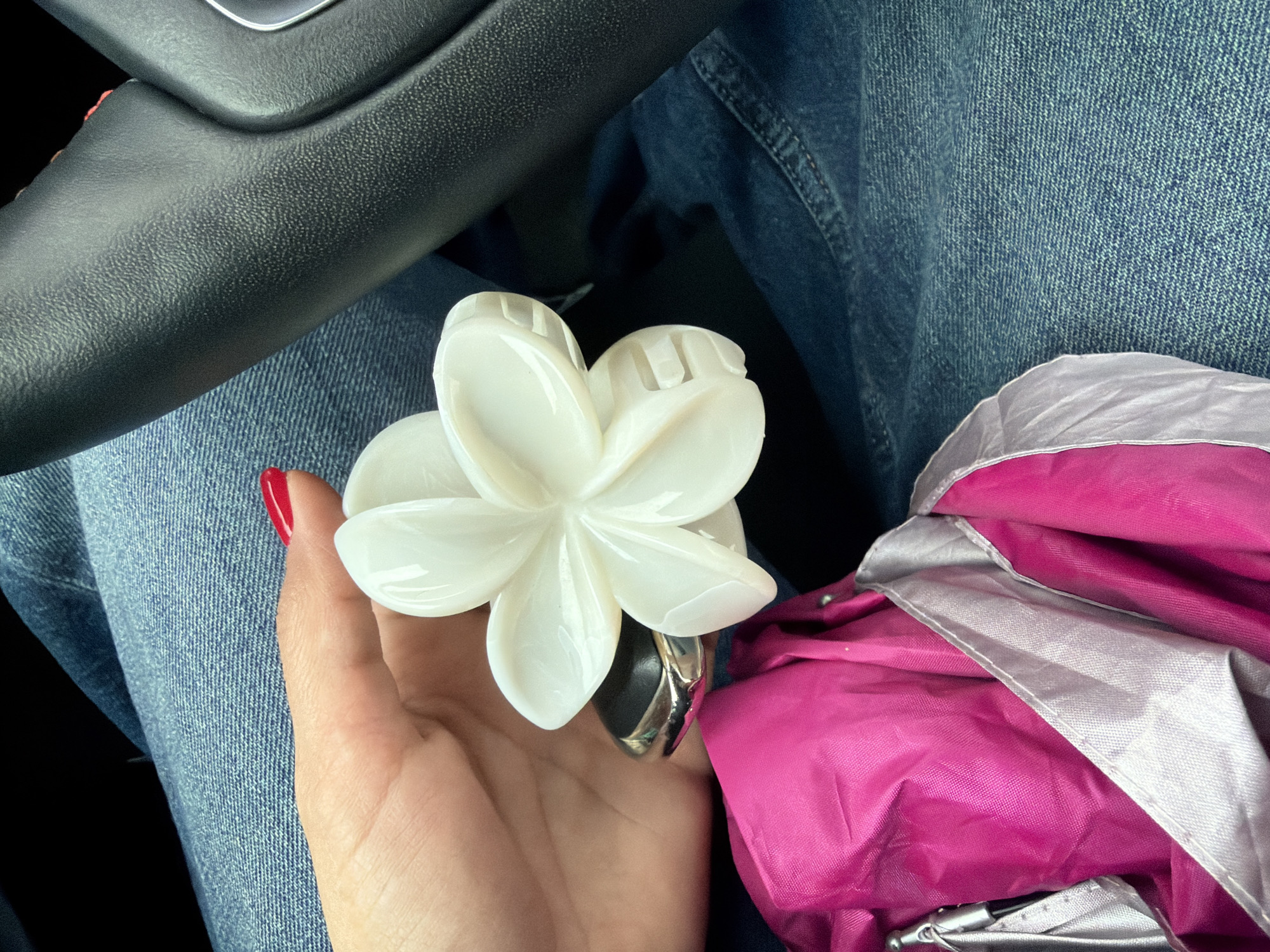 Person with hair clip sits in car during winter