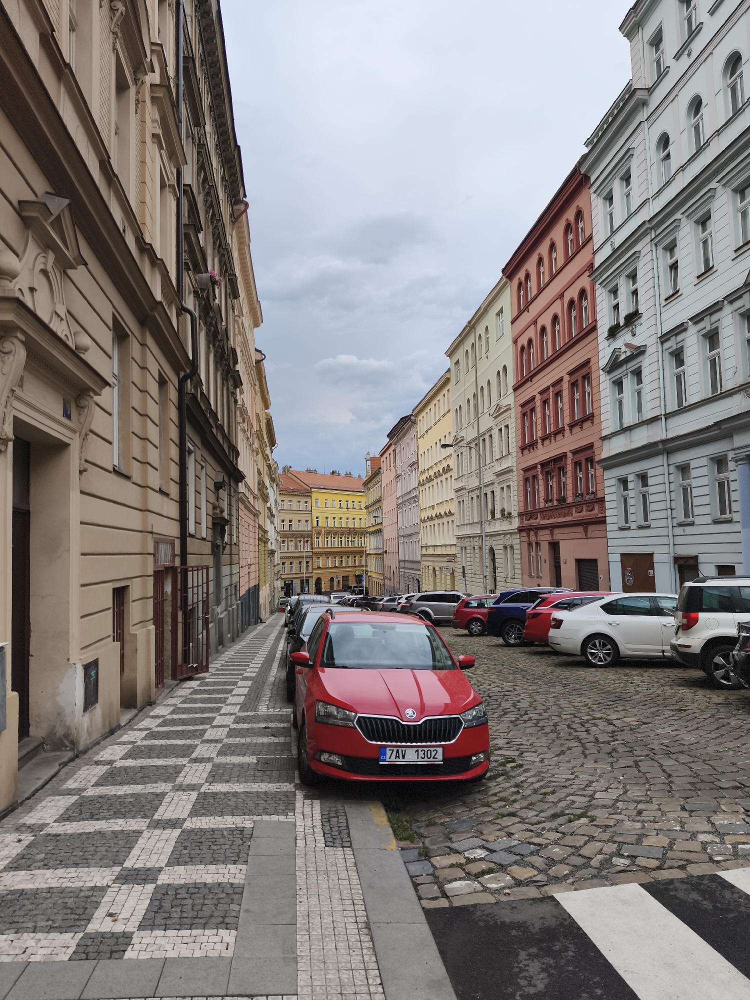 Cobblestone street cuts through Prague's historic colorful old quarter