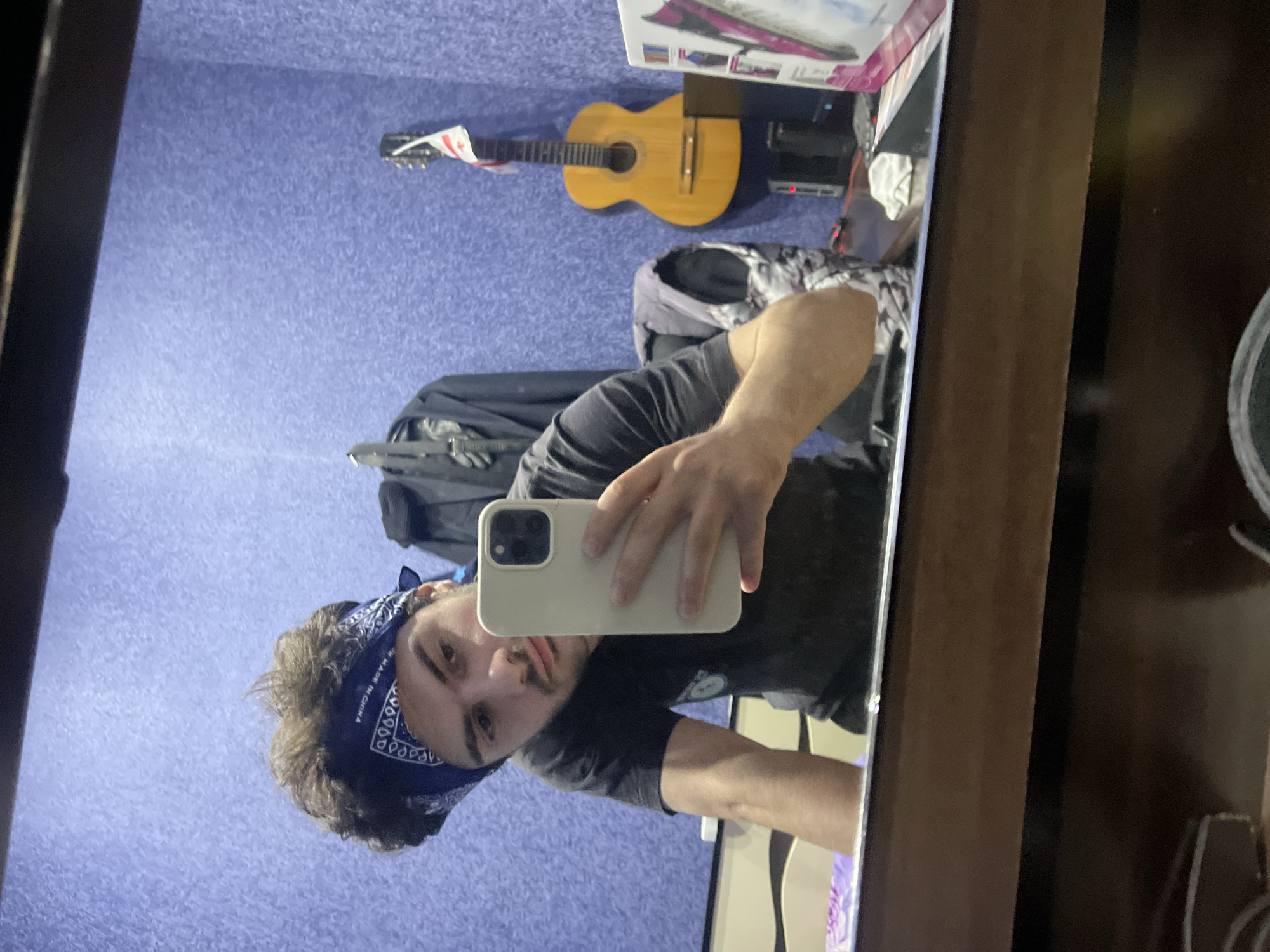 Young man takes mirror selfies in Tbilisi bedroom